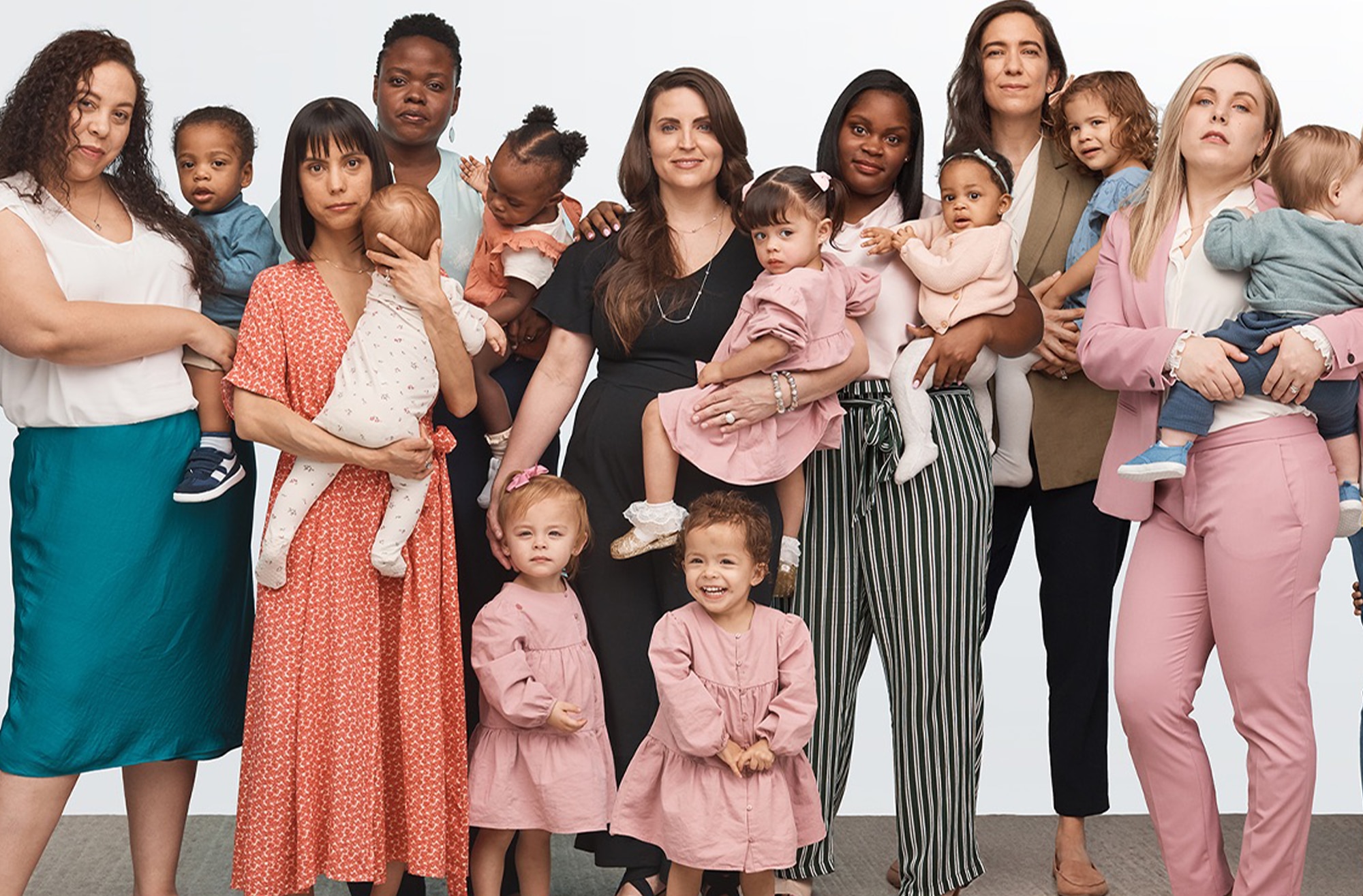 Image of a group of 7 mothers and their children standing in a line