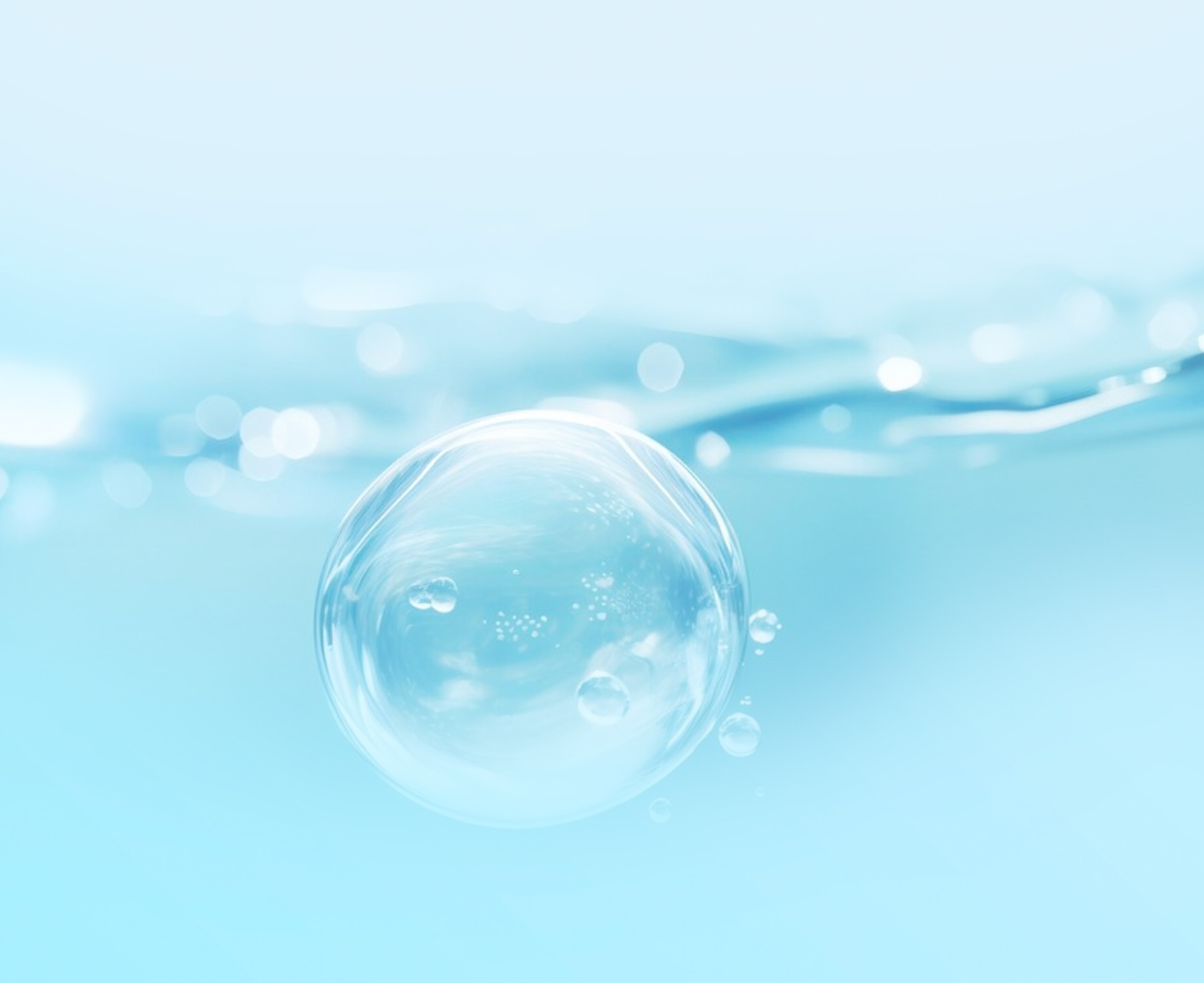 Close up image of a liquid, there is a large bubble in the forground