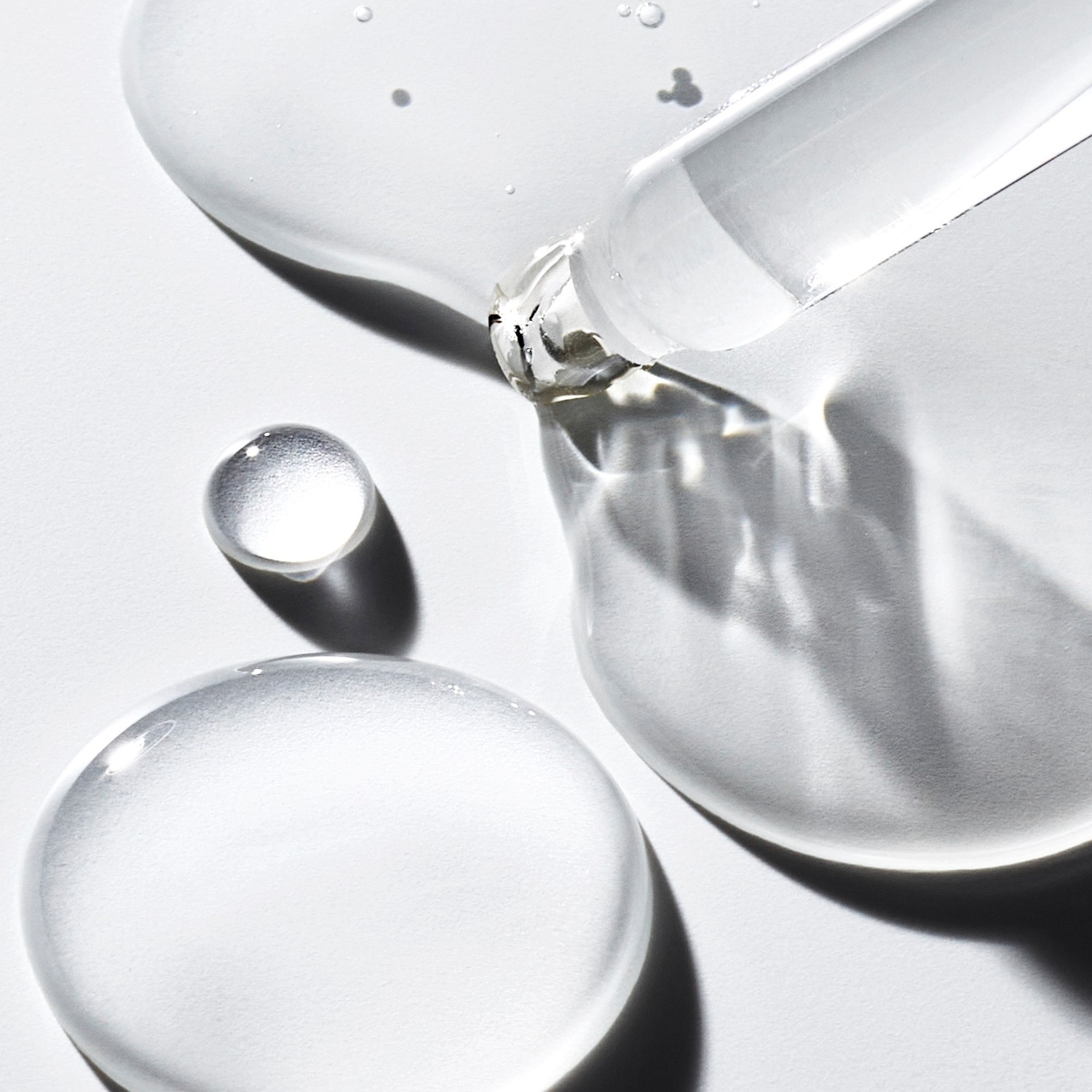 close-up texture image showing monochrome bubbles and a pipette