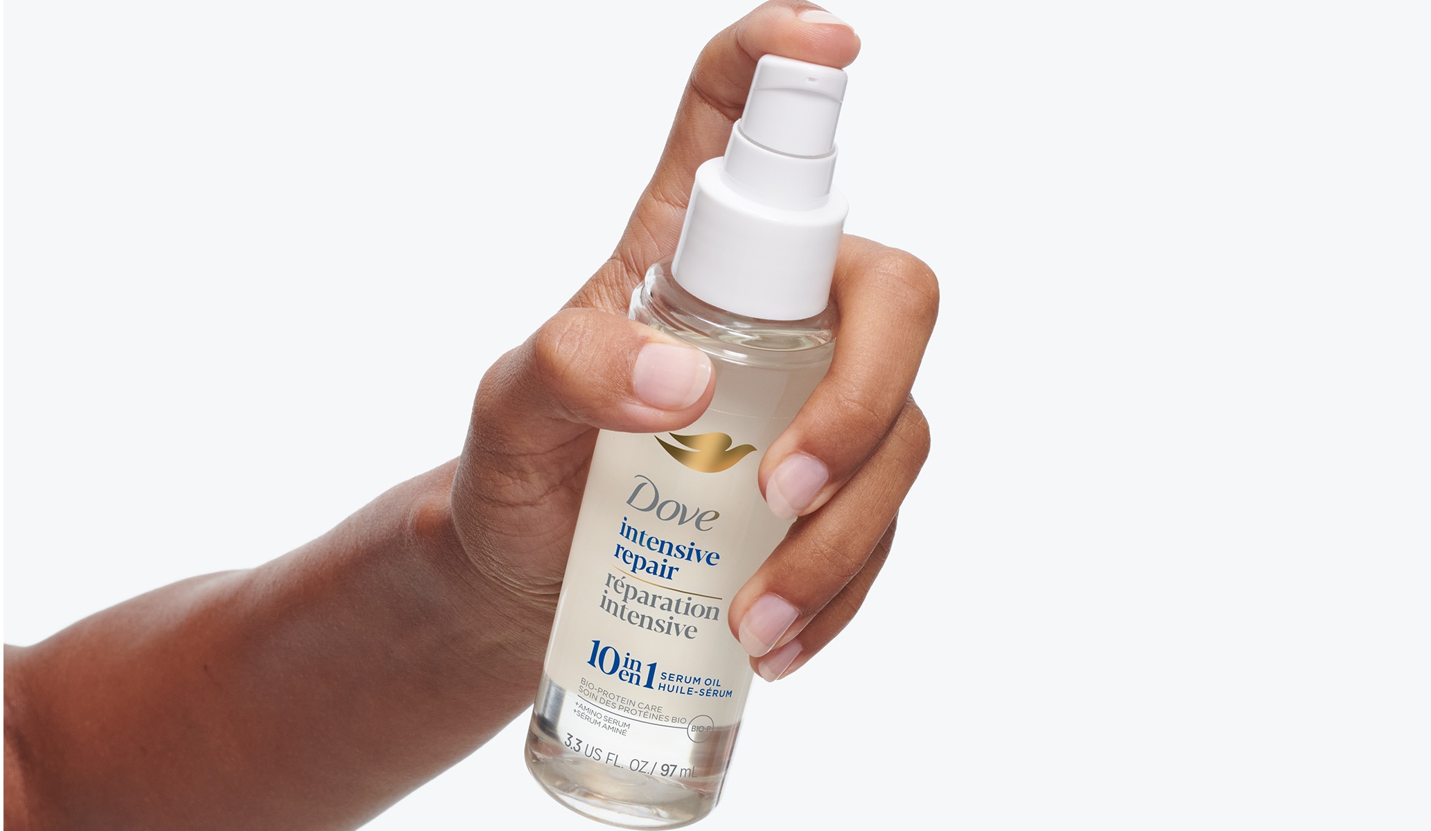 A hand holding the Dove Intensive Repair 10-in-1 serum 