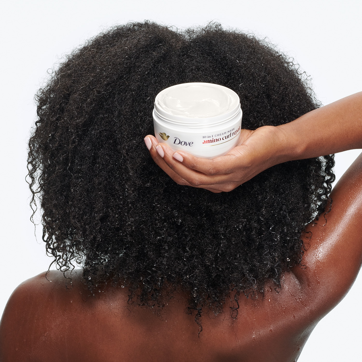 Product in-use with packaging shot, showing the Dove Amino Curl Repair Mask