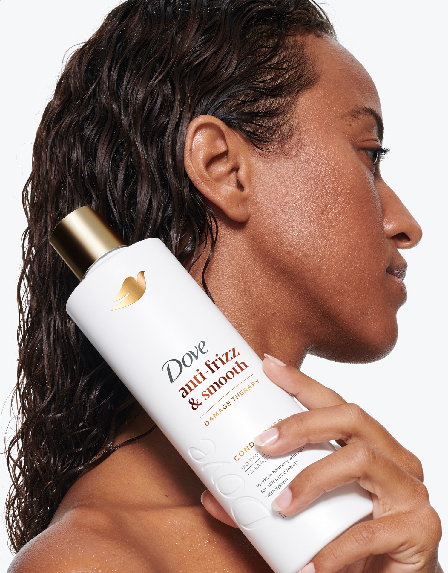 Product in-use with packaging shot, showing the Dove Anti-Frizz & smooth