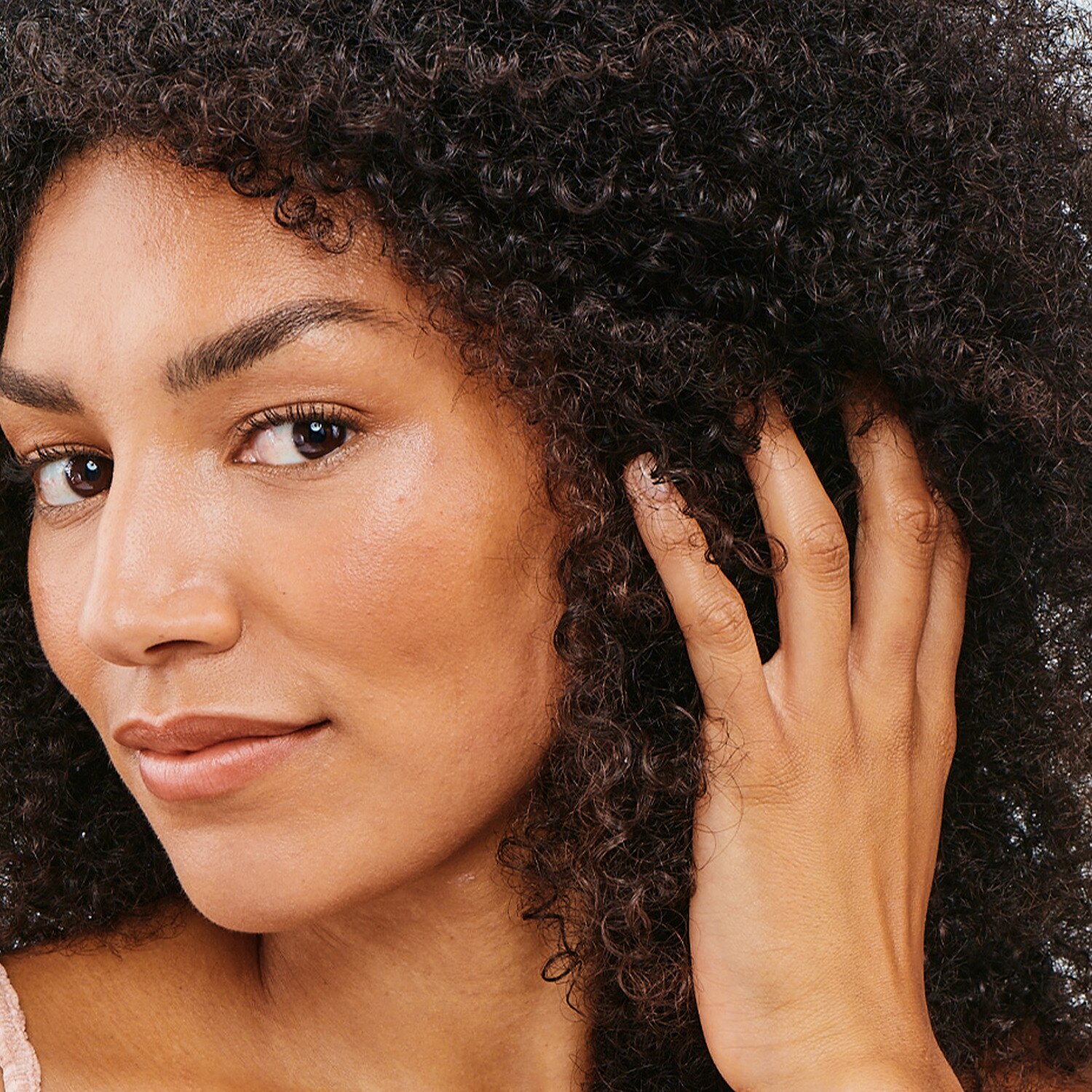 A woman with long curly black hair