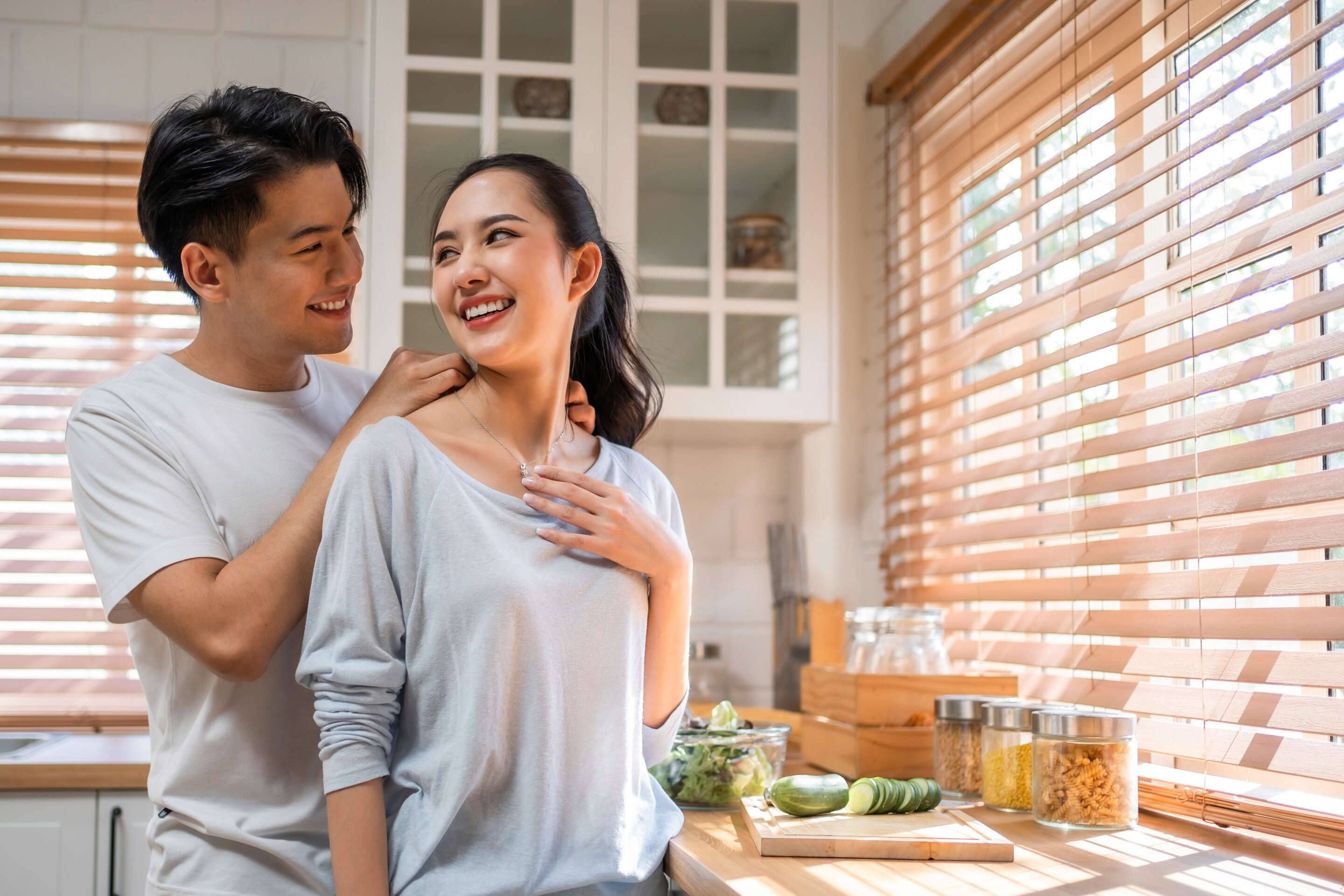 An Asian couple looking at each other lovingly.