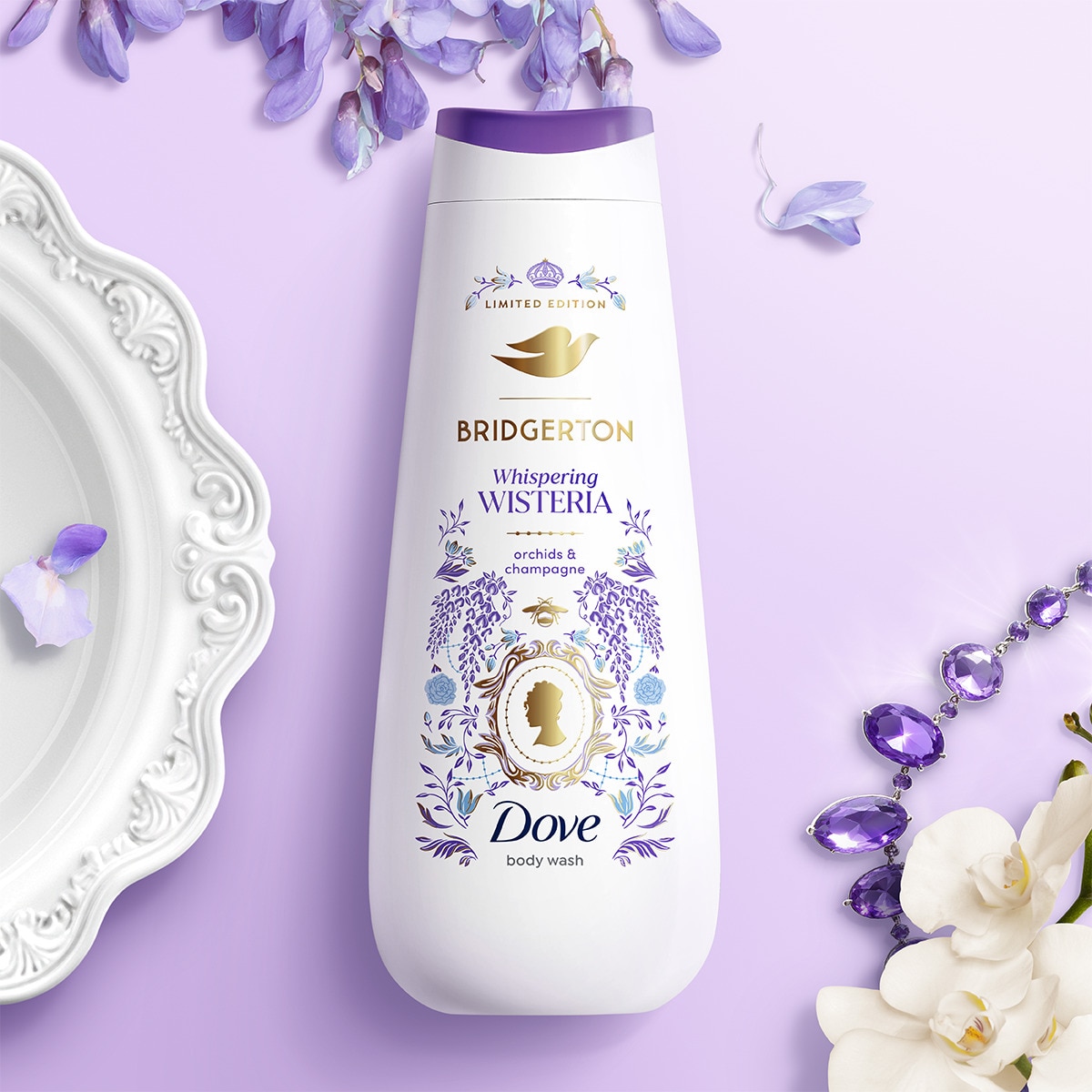 Whispering Wisteria body wash against a purple background with a white plate and purple beads  in the corner. 
