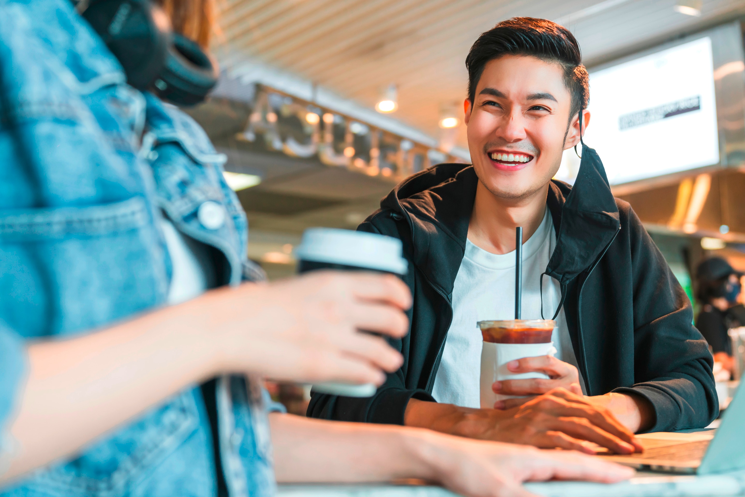 Man laughing with his date.
