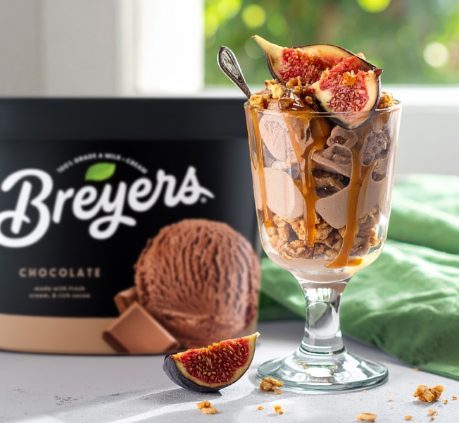 Crunchy breakfast sundaes with winter fruit and caramel sauce on top