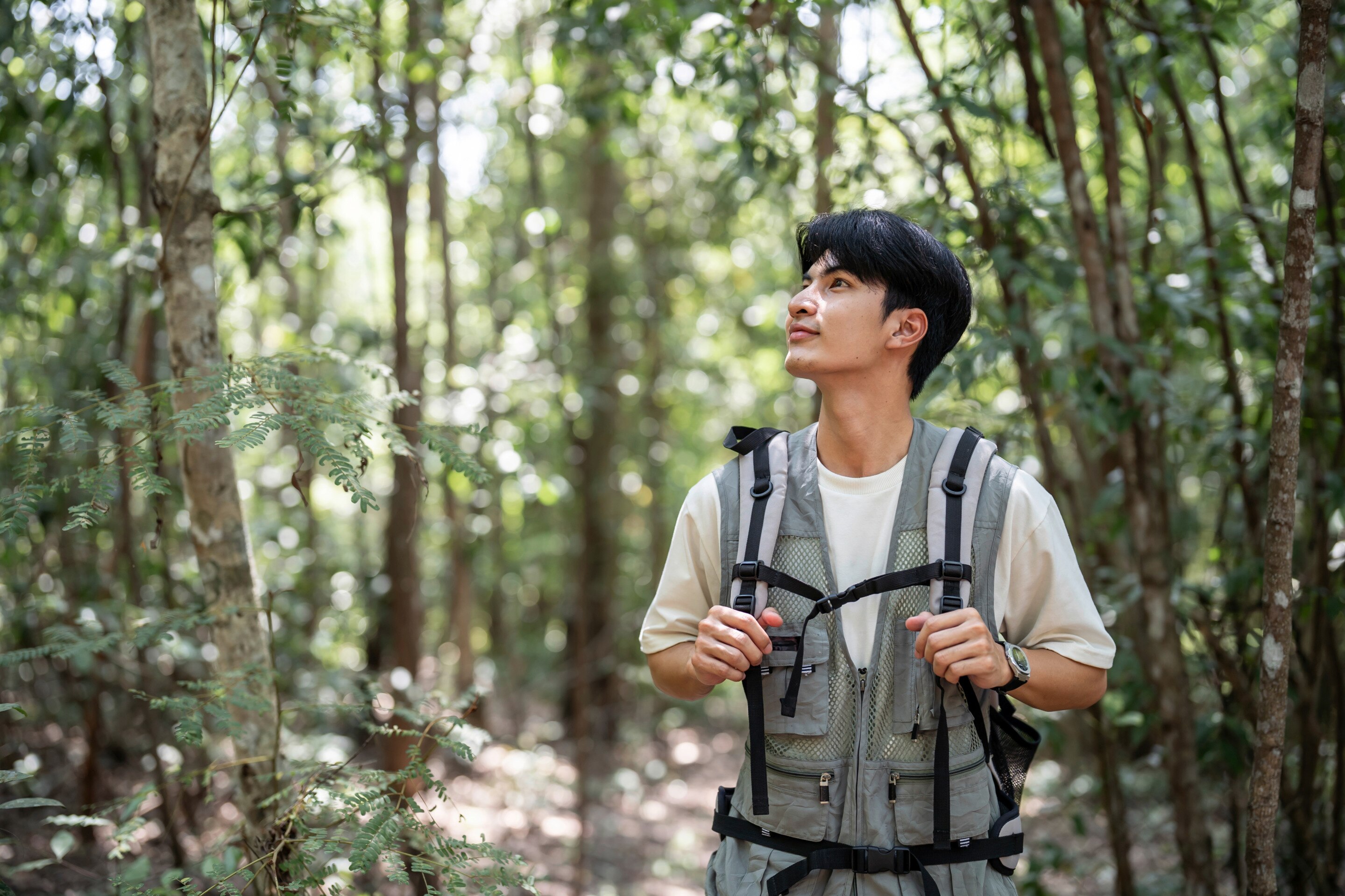 A man prepares the ingredients for a smoothie bowl in his kitchen.