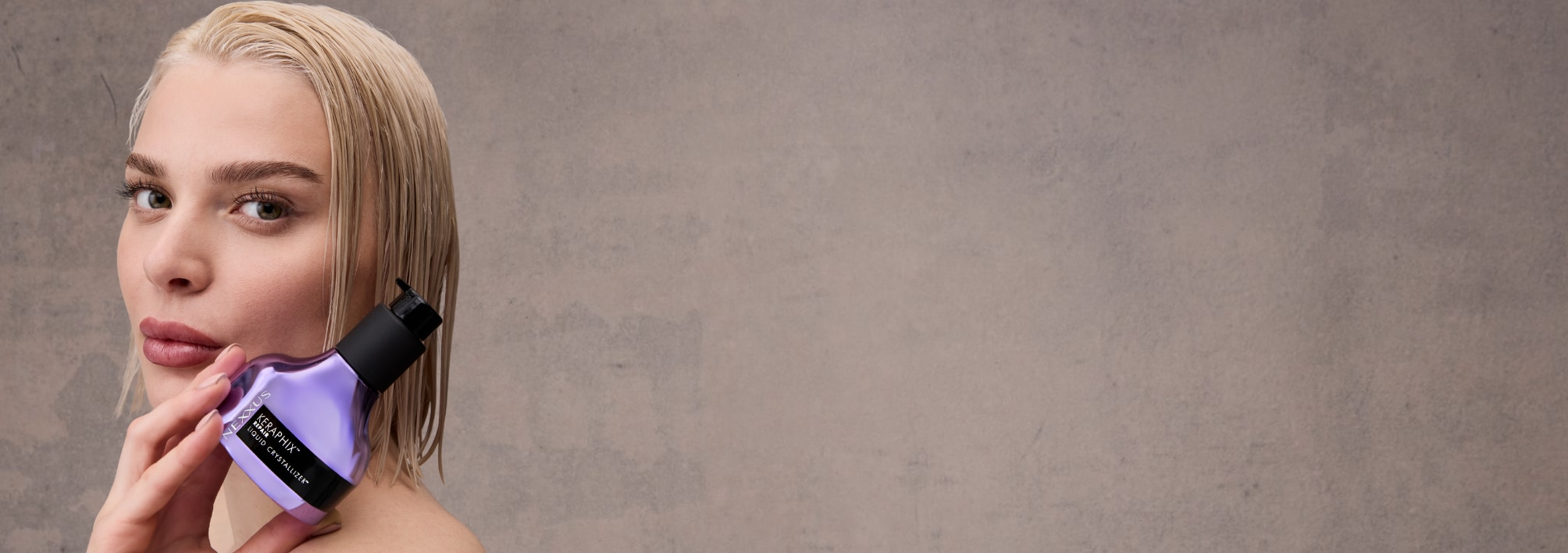 A model holding KERAPHIX™ Liquid Crystallizer Reconstructive Leave-In Treatment