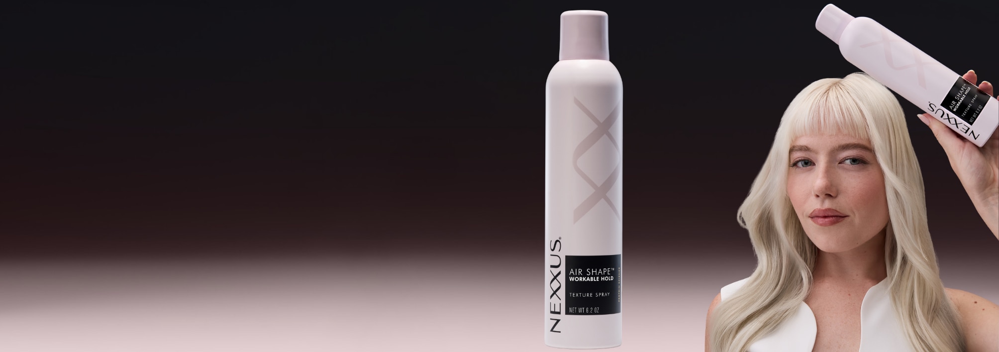 A model holding Air Shape™ Workable Hold Texture Spray