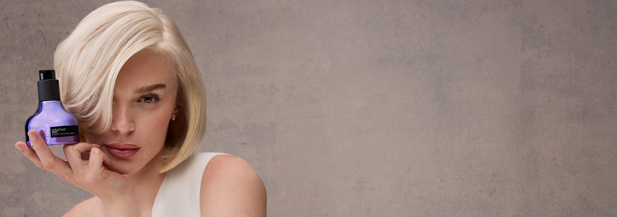 A model holding KERAPHIX™ Liquid Crystallizer Reconstructive Leave-In Treatment