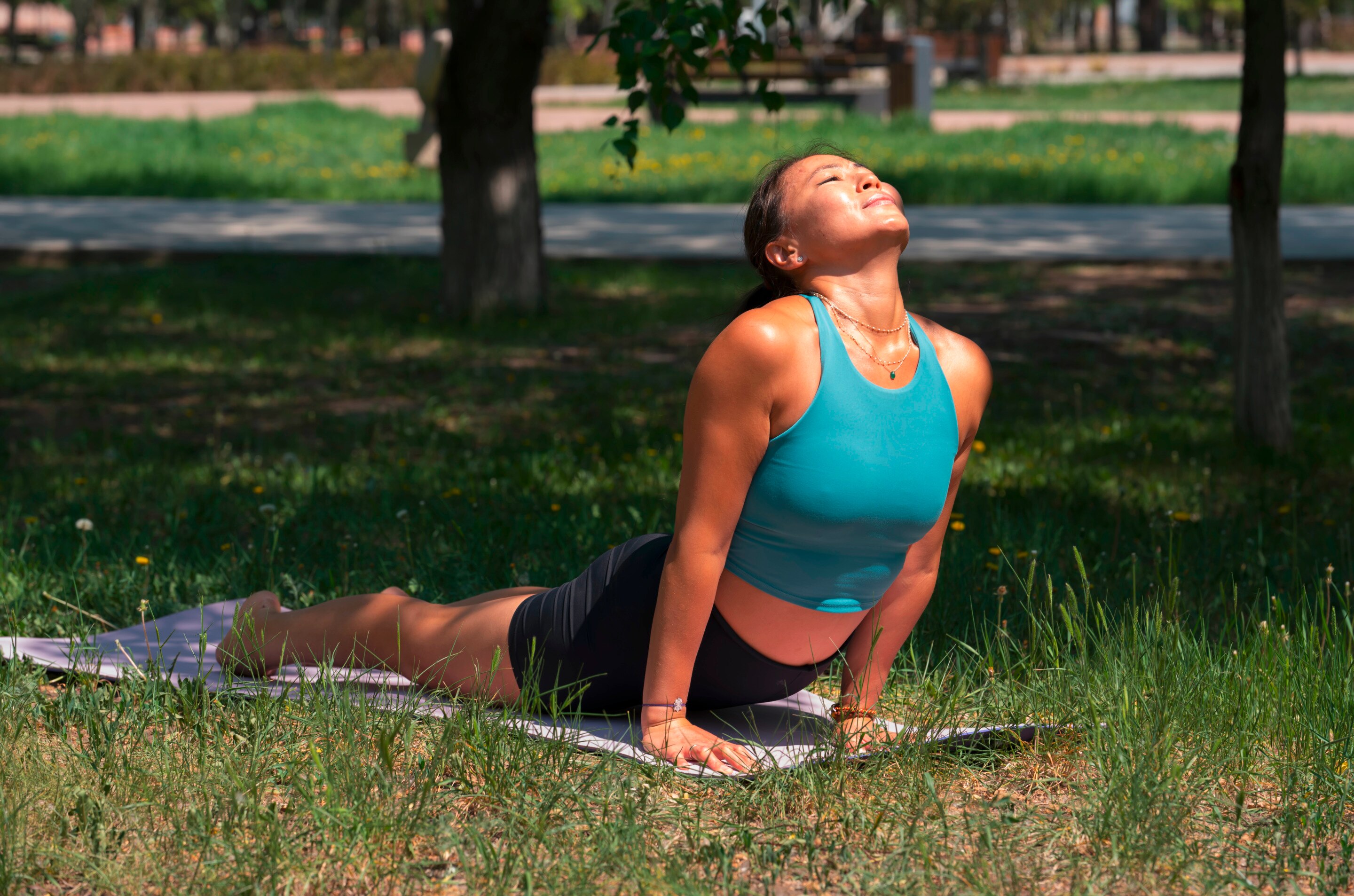 Woman doing a yoga pose in the park.