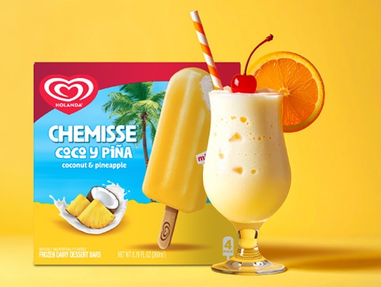 Creamy Virgin Piña Colada Mocktail next to a box of Chemisse Coconut & Pineapple Bars