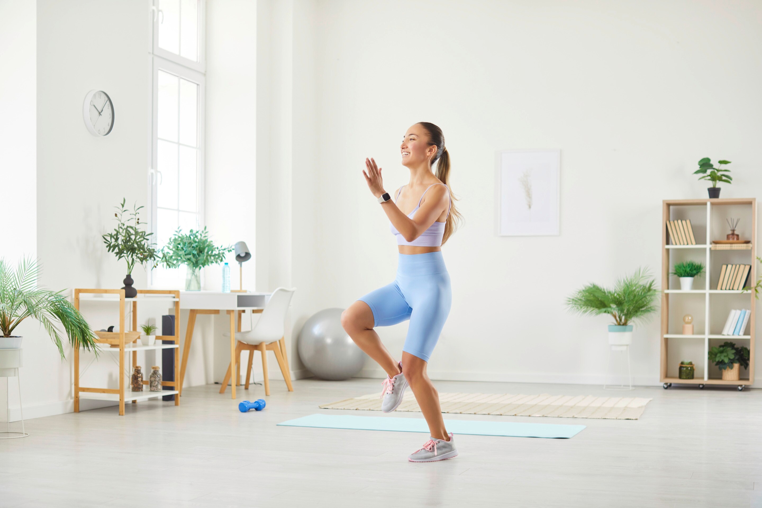 Woman in exercise clothes walking in place at home.
