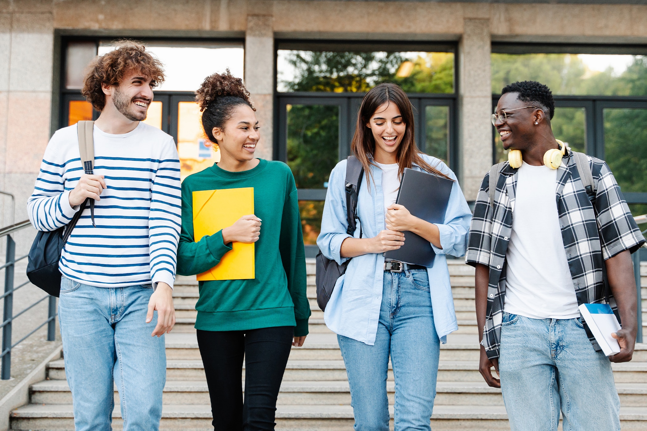 Group of students laughing together outside a college with no sign of stress sweat