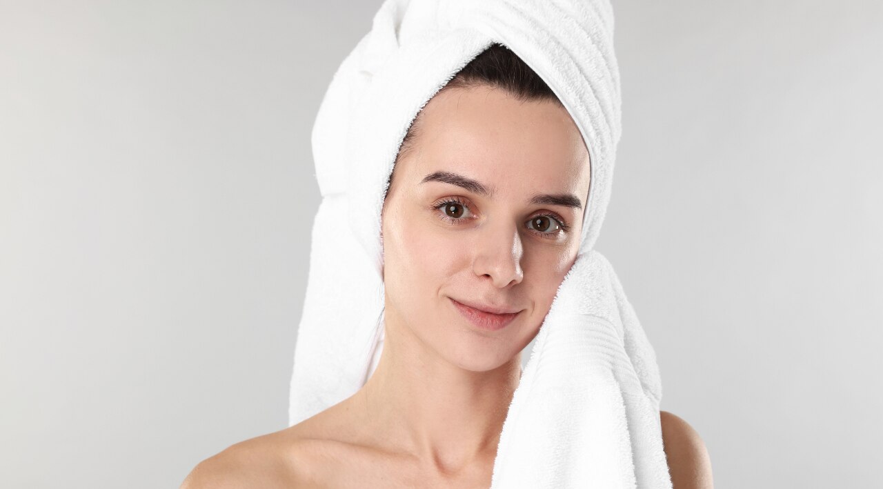 2. Pat your skin slightly damp instead of fully drying it.