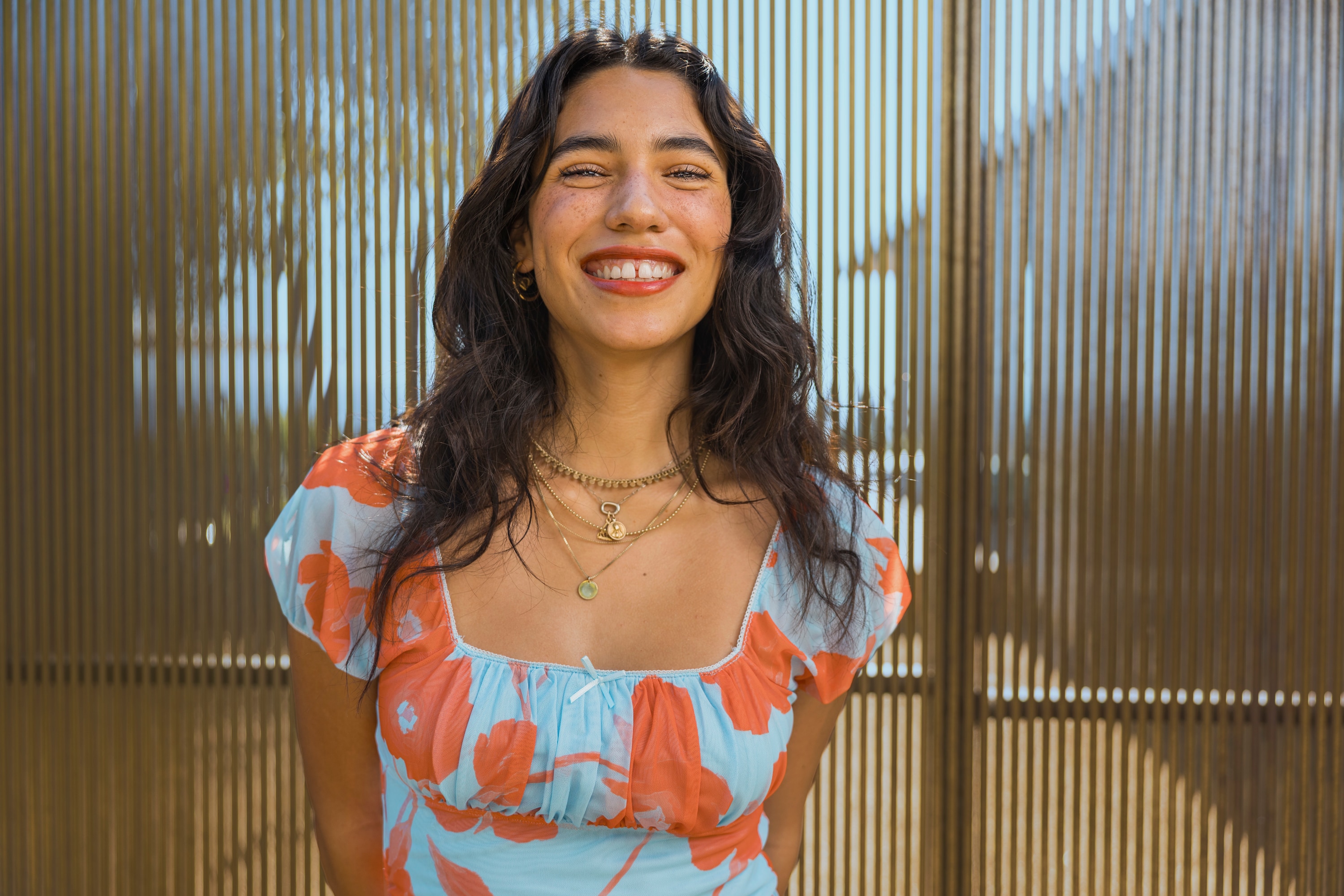 A female standing posing for a photo in a pretty dress 