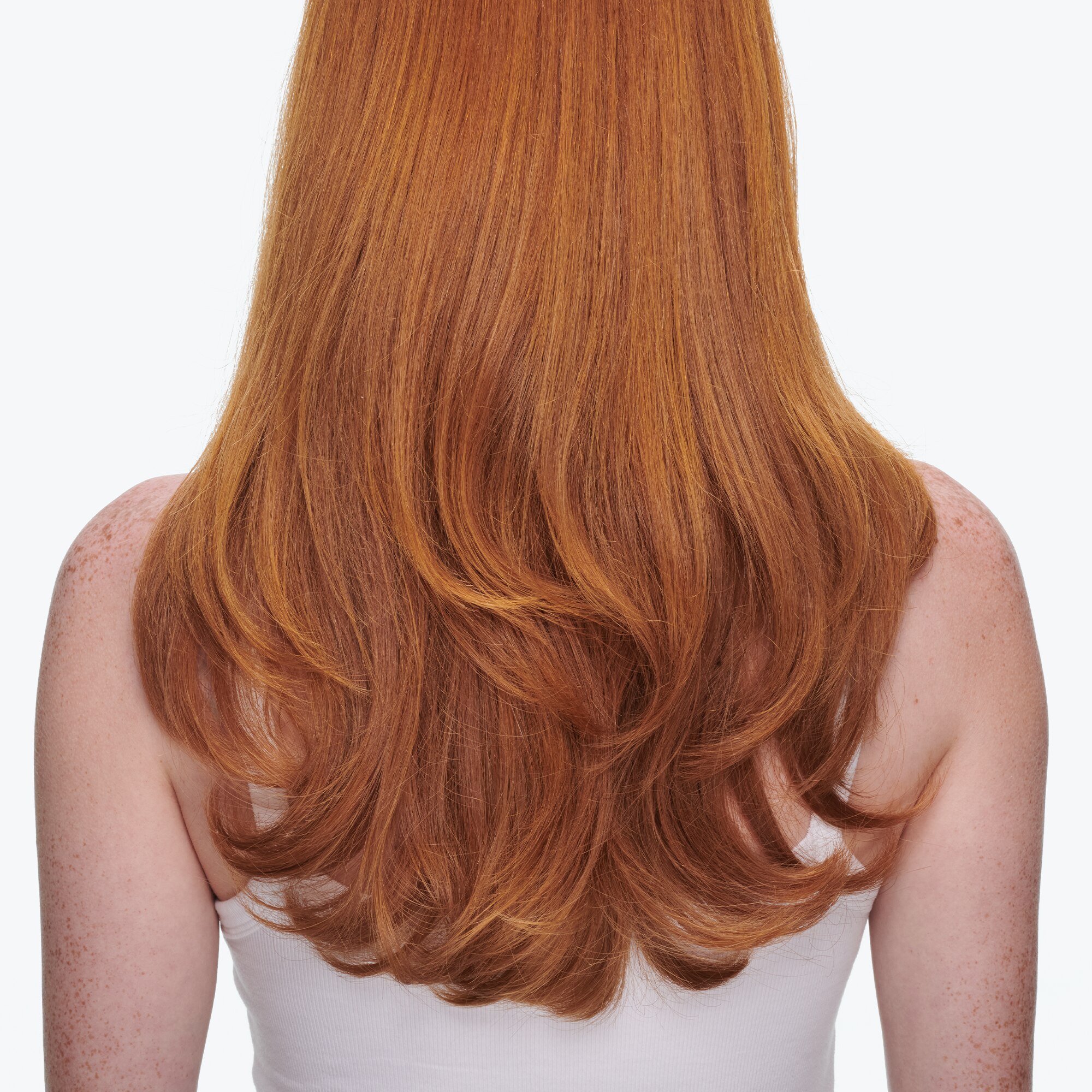 This image shows a long, layered hairstyle in a copper red color, similar to those found in styling portfolios. 