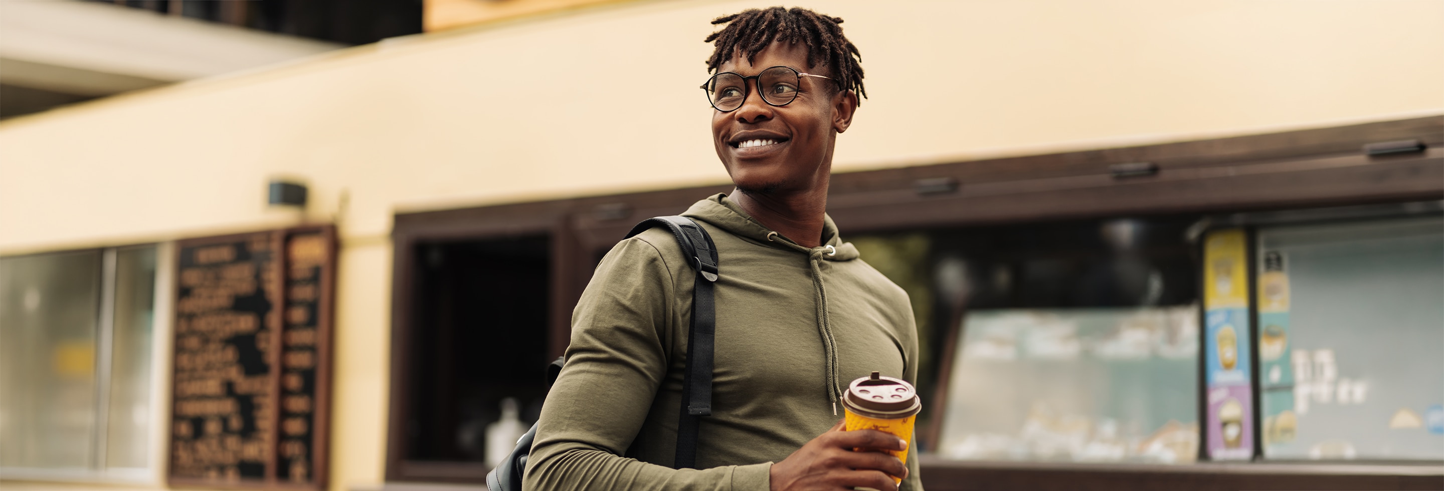 Young man on his commute to work drinking coffee with no sign of morning sweats