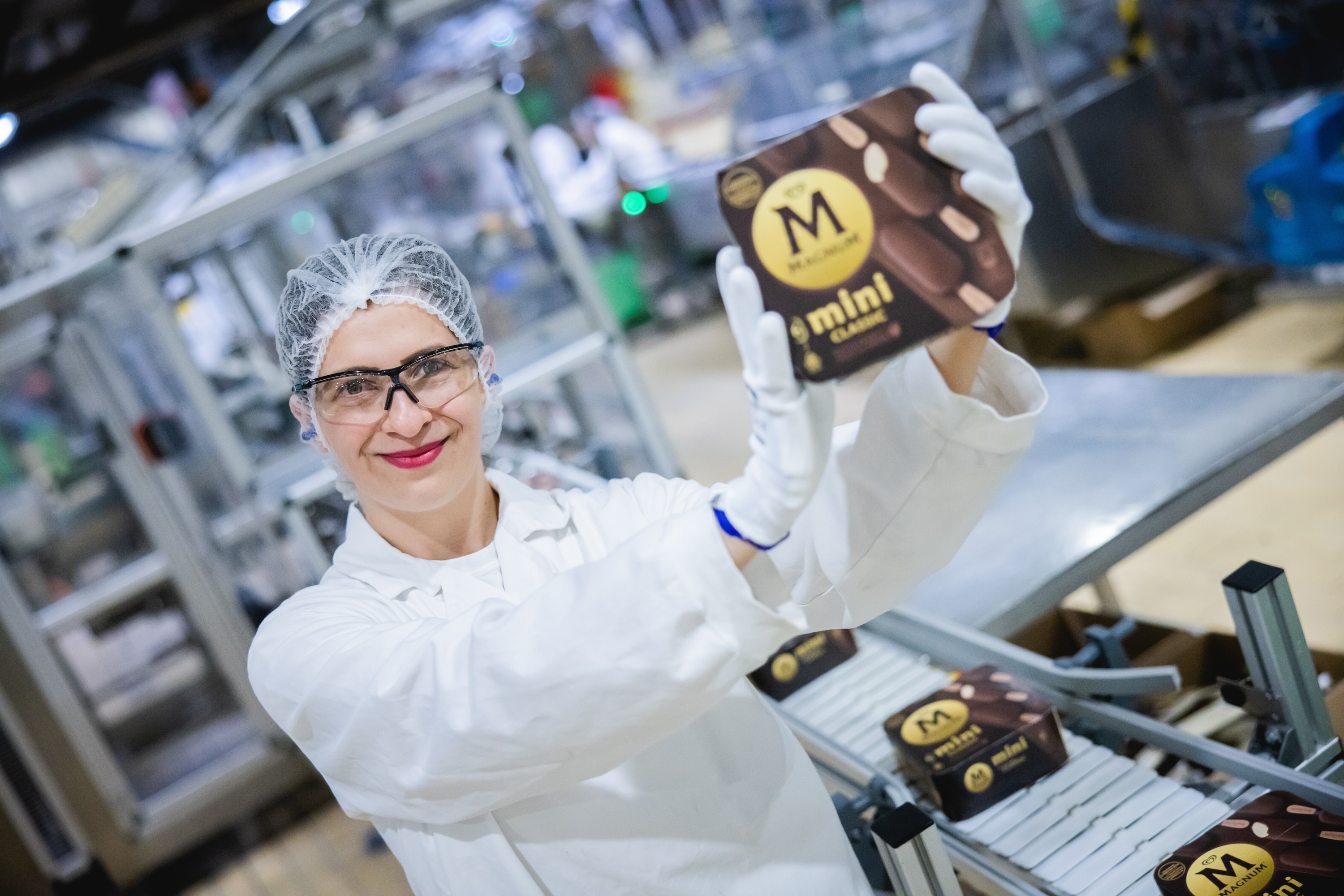 TMICC Factory worker holds up a box of Magnum Ice Cream - Frontline Heroes