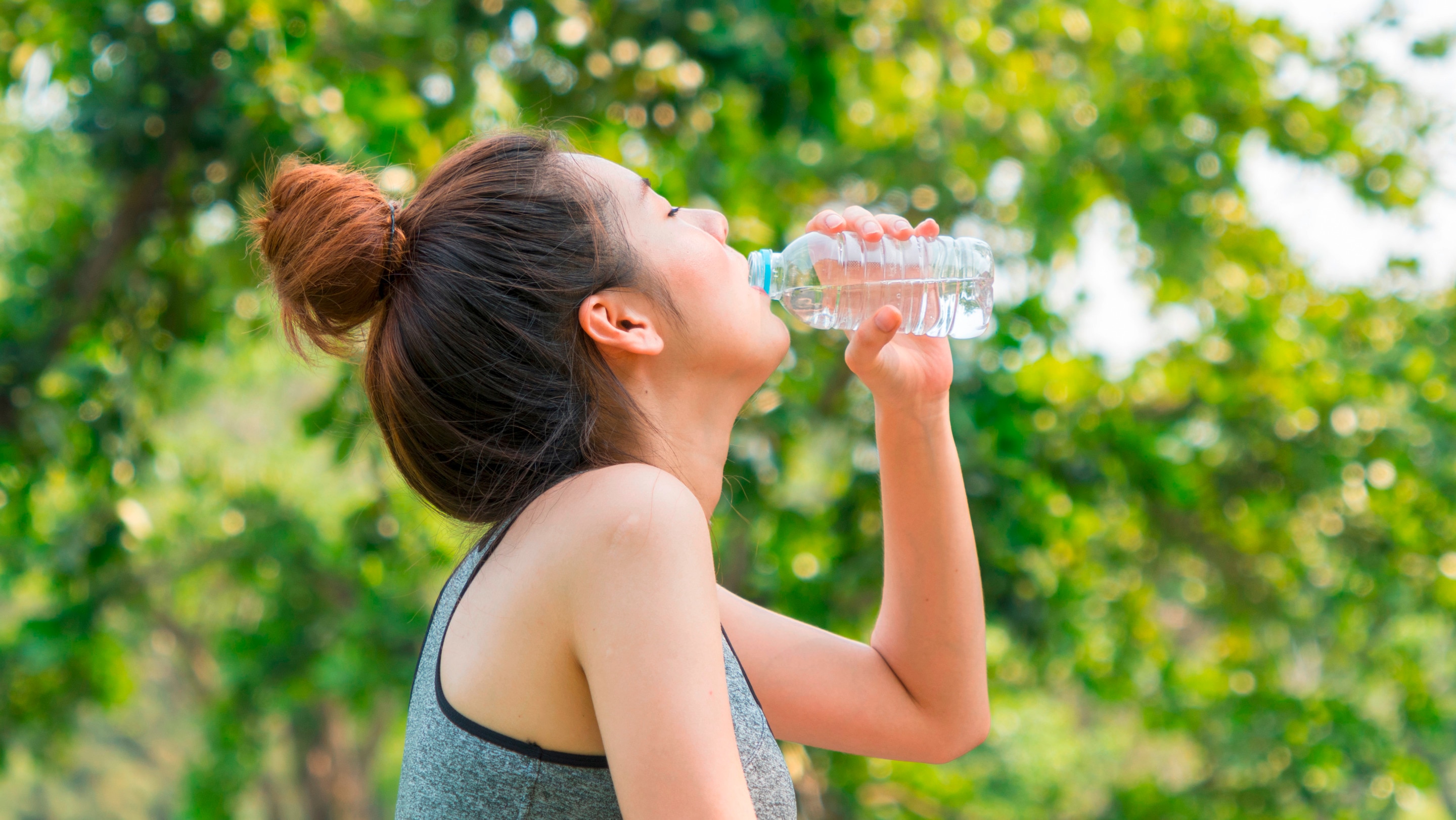 Closeup shot of woman drinking bottled water.