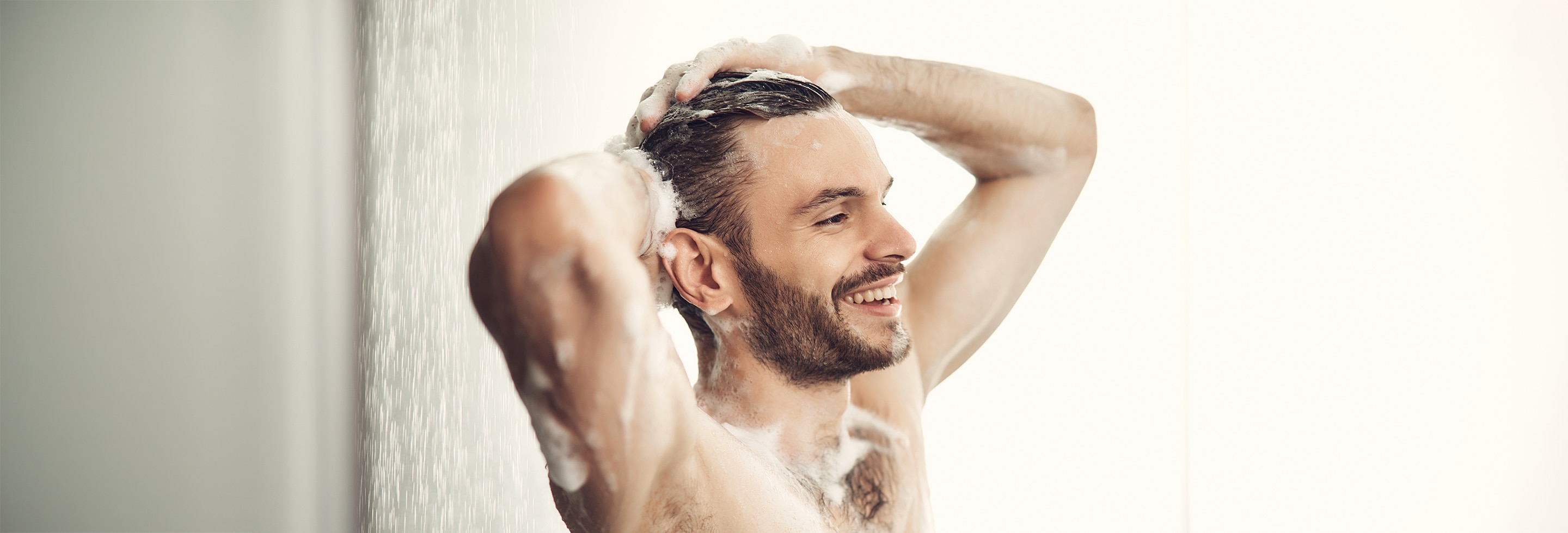 Happy man enjoying the benefits of a shower