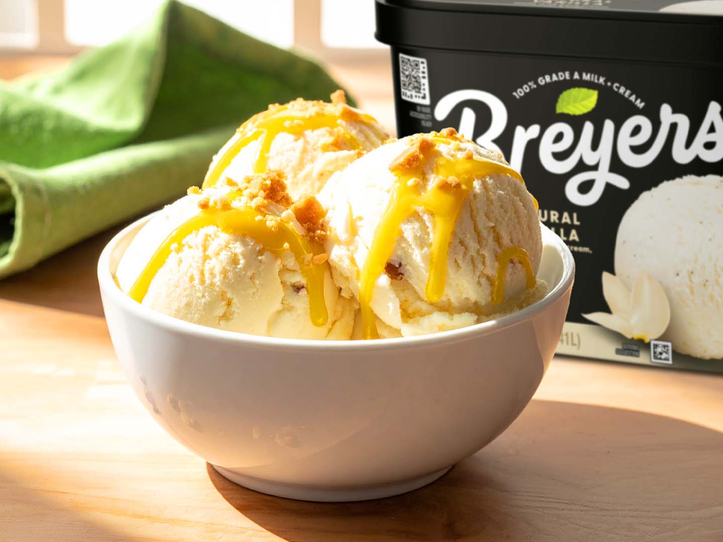 Creamy vanilla ice cream sundae with bright yuzu syrup