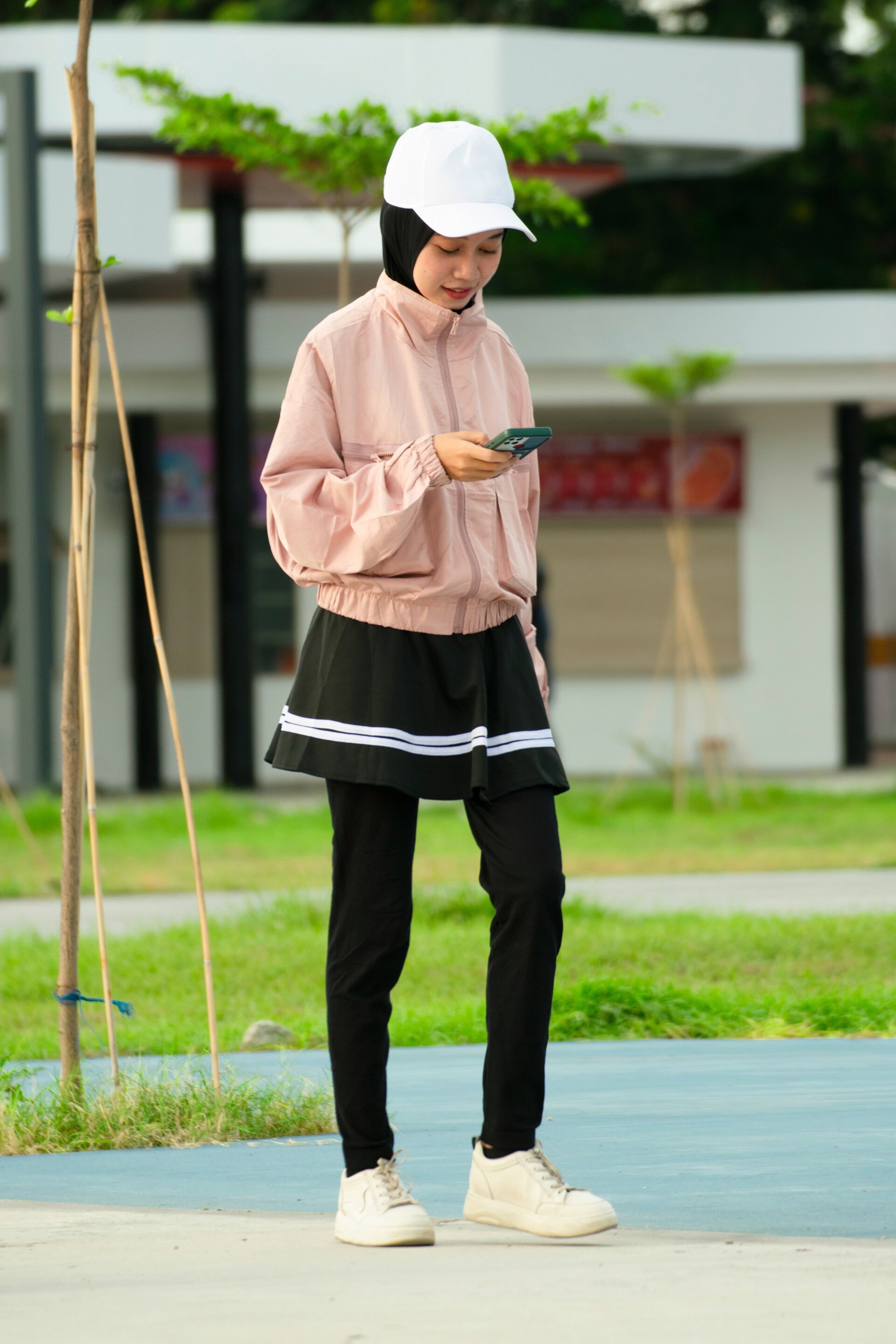 wanita berhijab sedang mengenakan pakaian olahraga untuk golf.