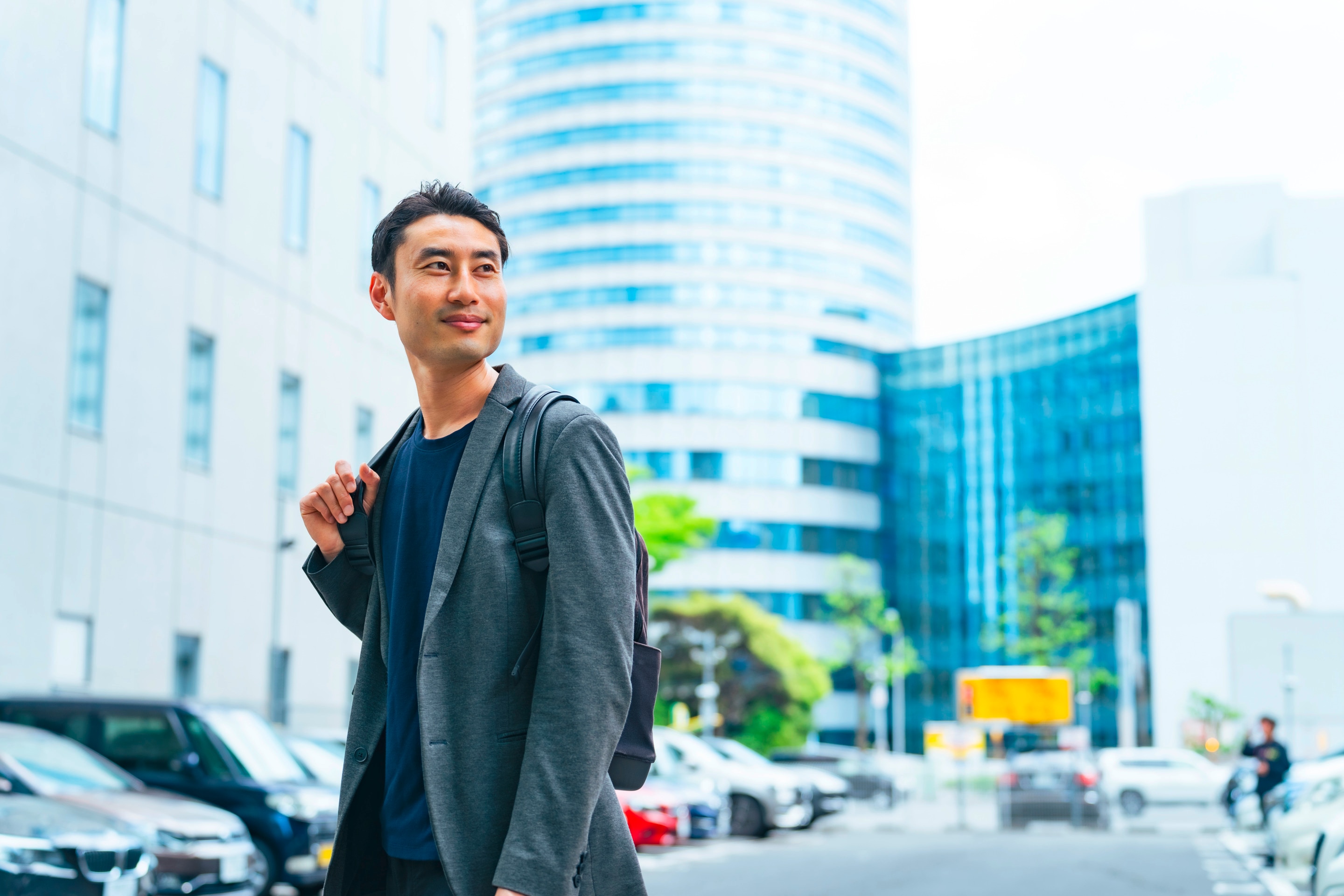 Man in work attire outdoors in a city.
