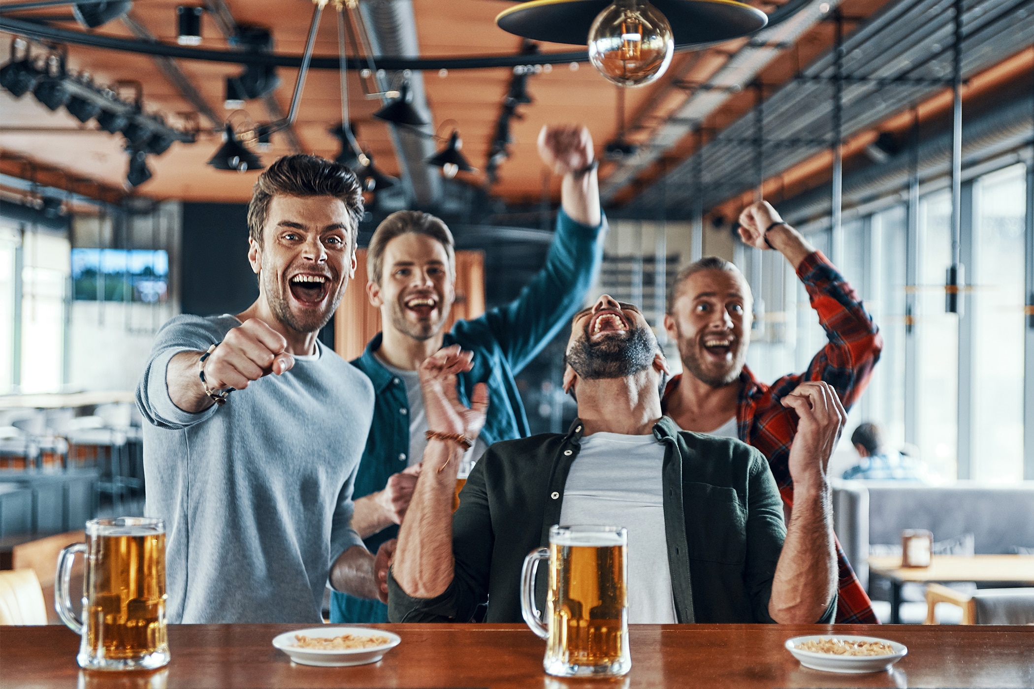 Group of friends watching soccer with no sign of anxiety sweating or stress sweat