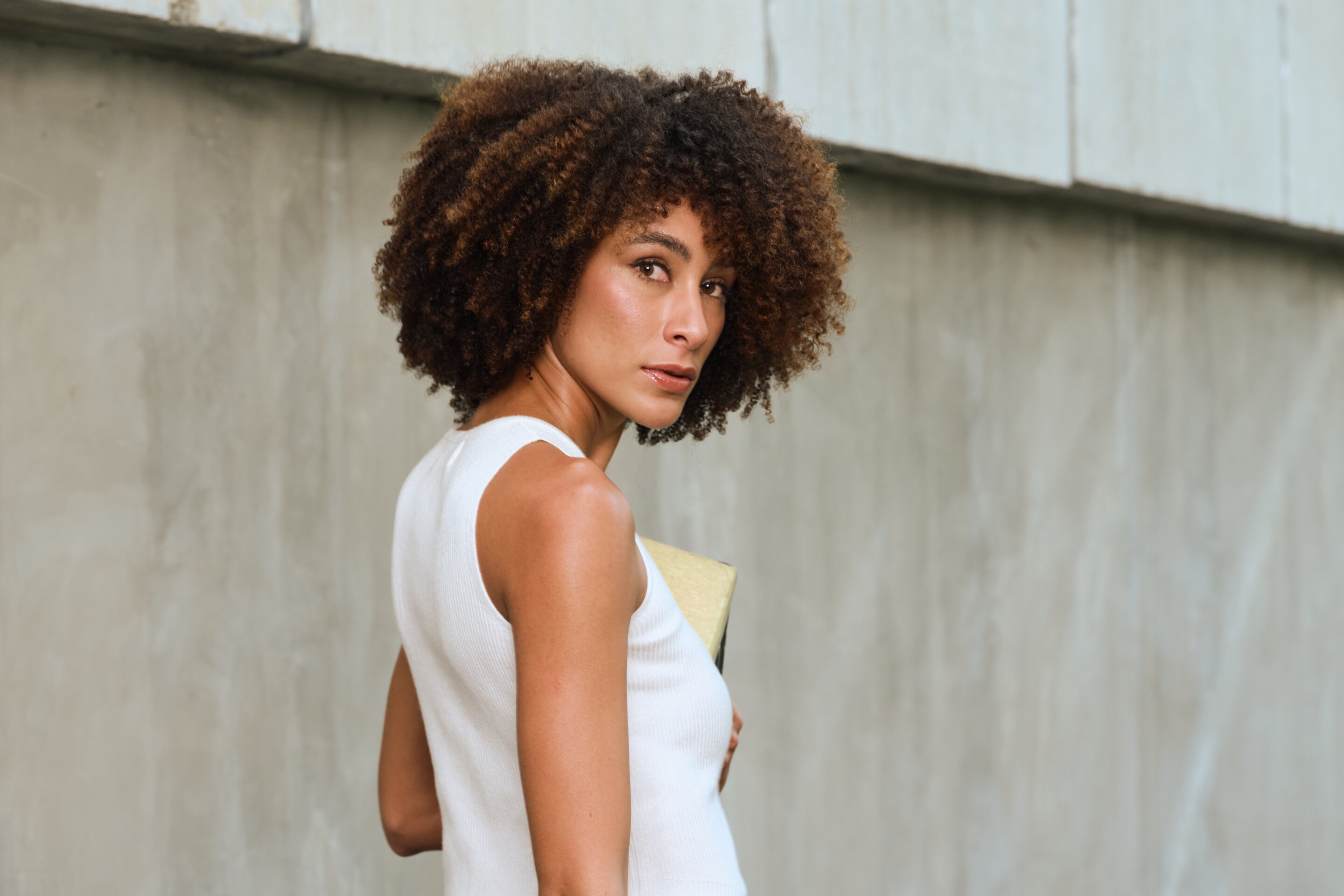 a model with straight black hair styled in a updo