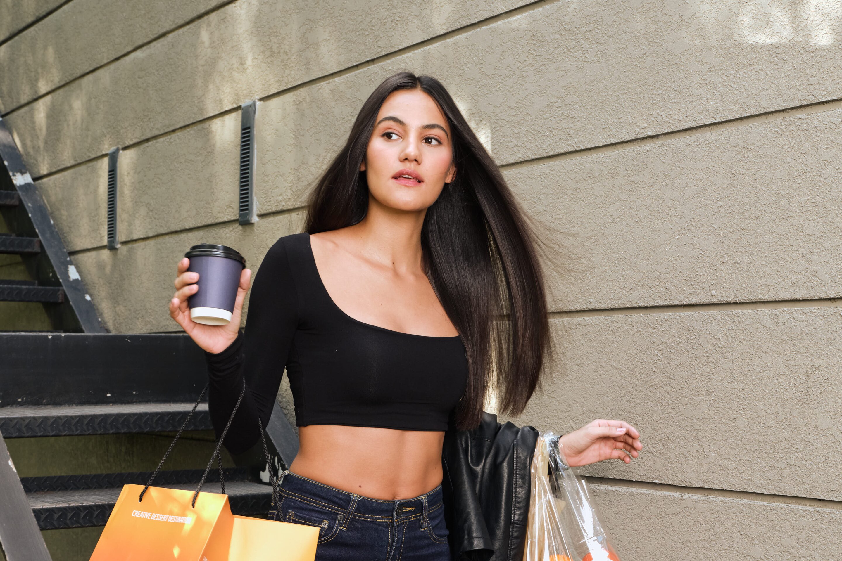 a model with straight black hair styled in a updo