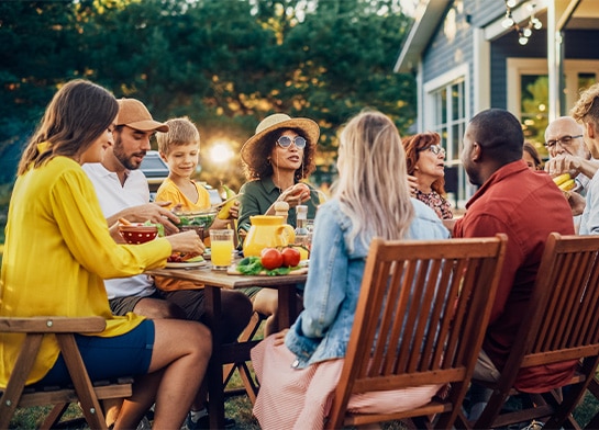 Family and friends enjoying an outdoor meal in summertime