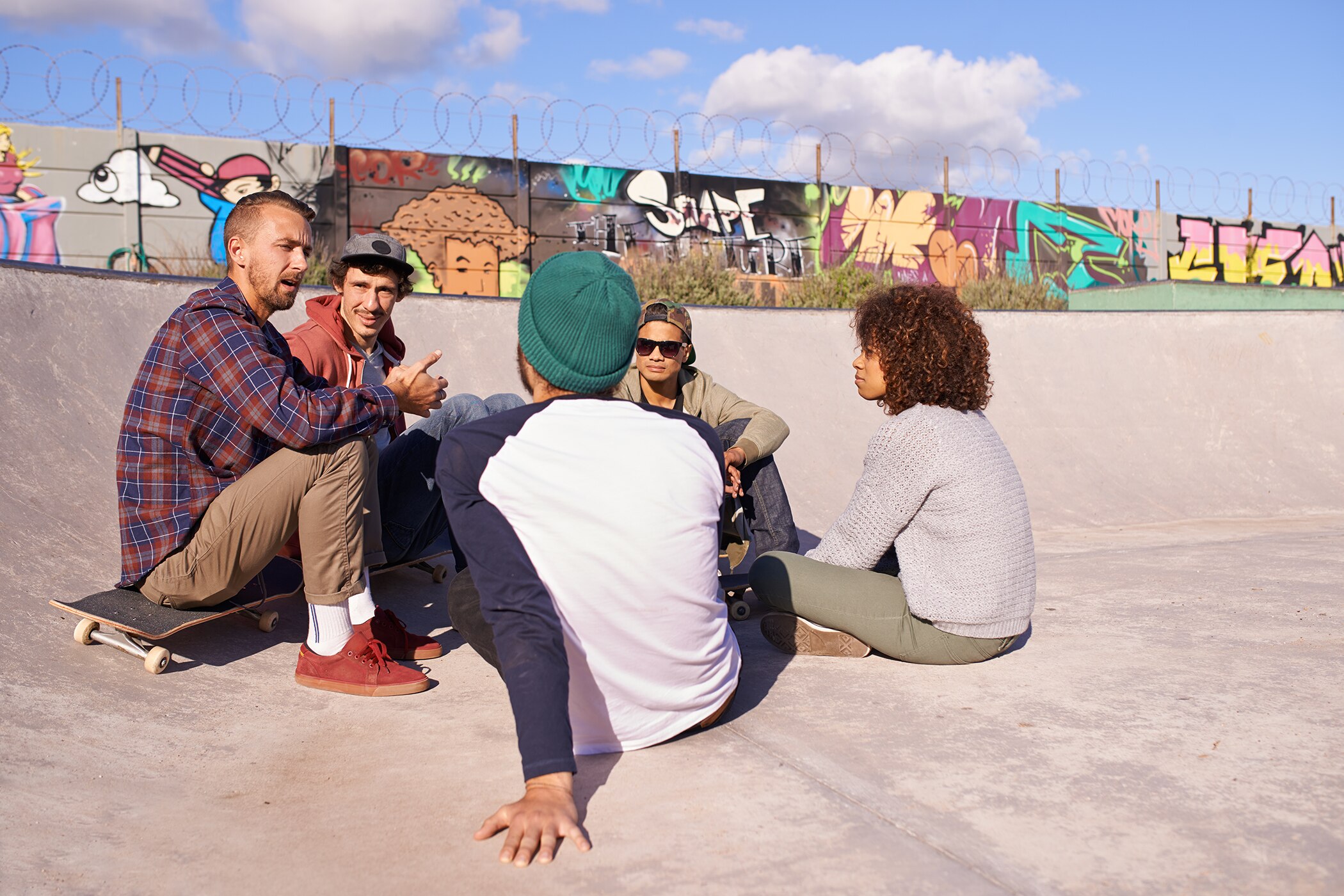 Group of Gen Z’ers hanging out together in a skate park