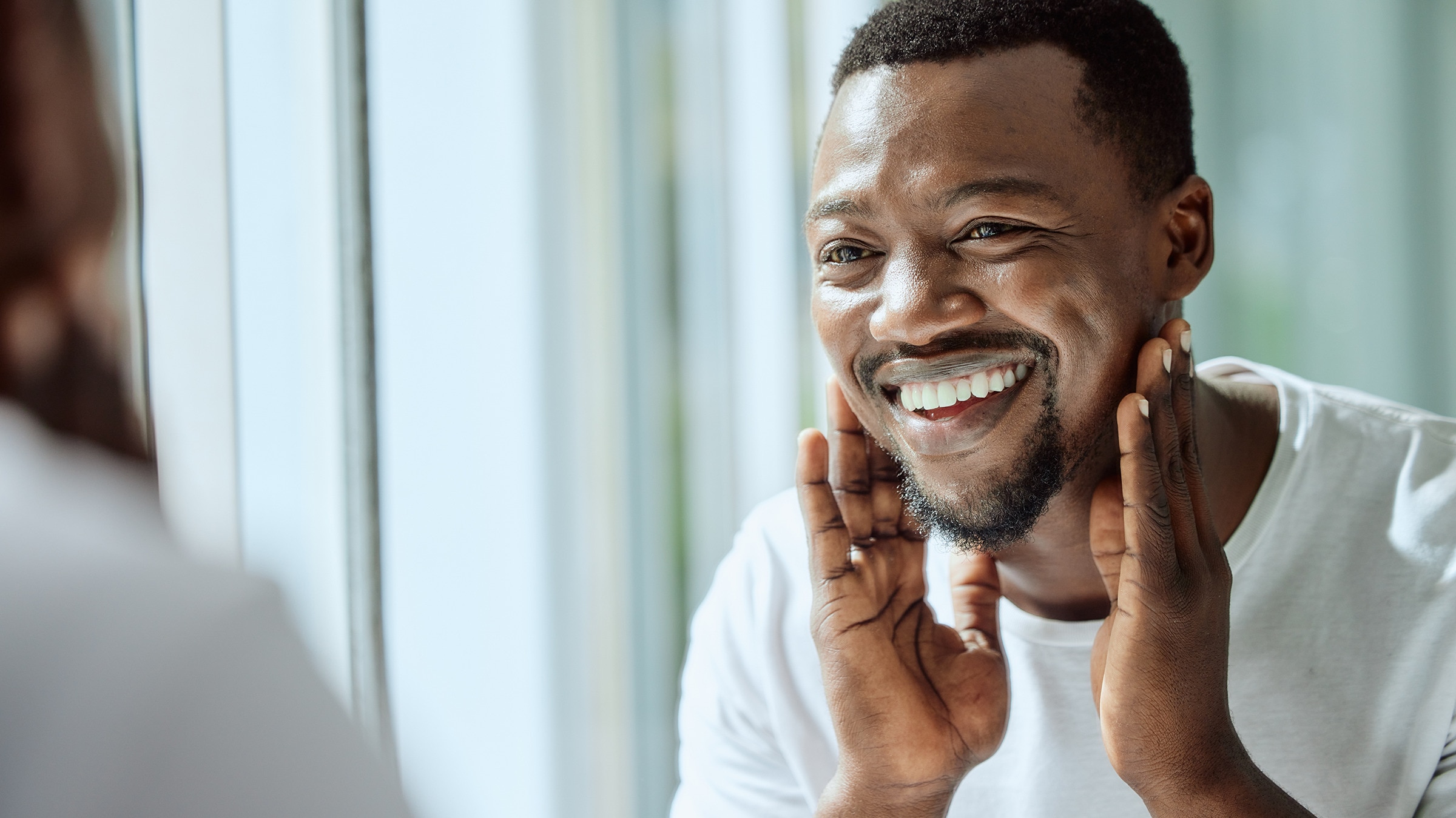 Man applying skin barrier repair product to his face