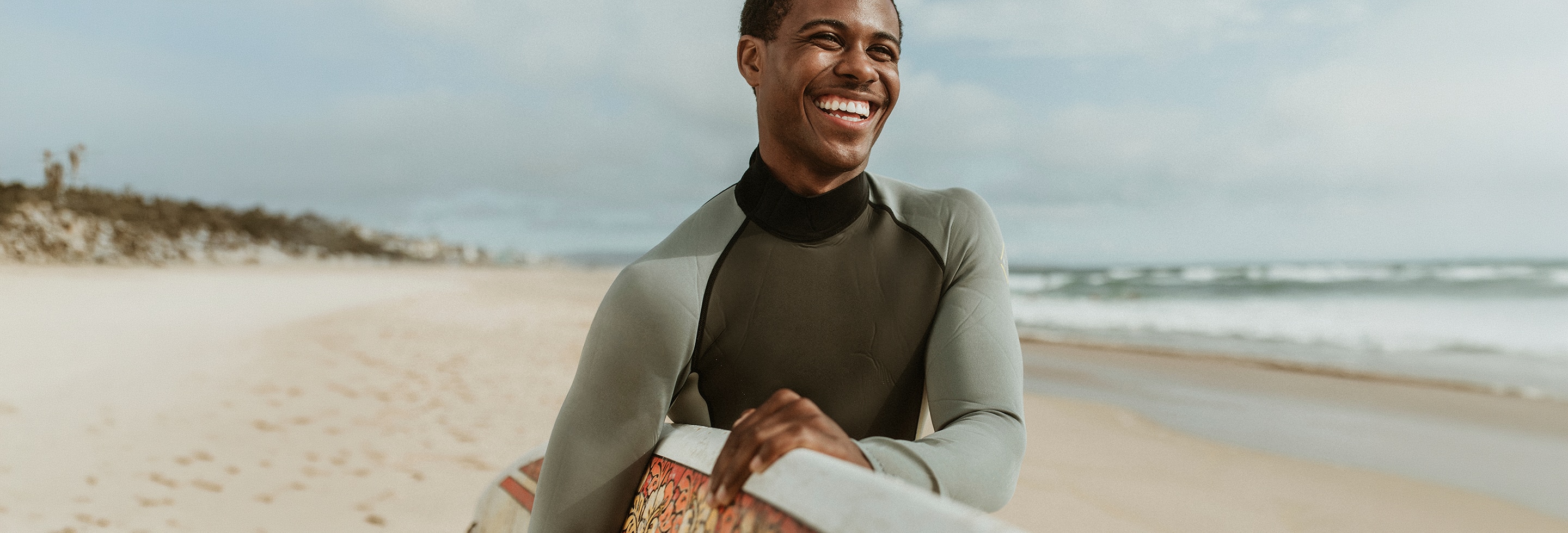 Surfer in wetsuit who wants to know how to get rid of body acne 