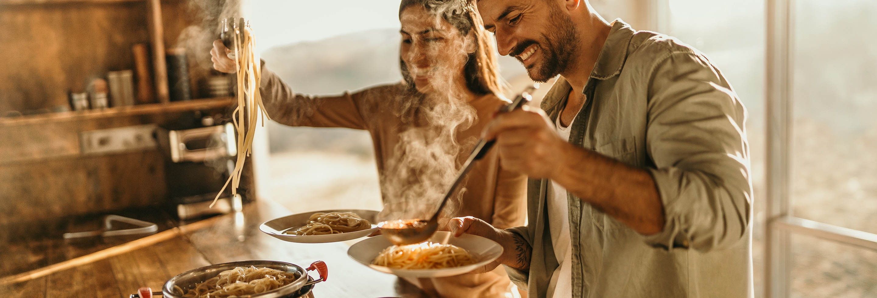 Man and woman dishing up pasta that may cause body odor 