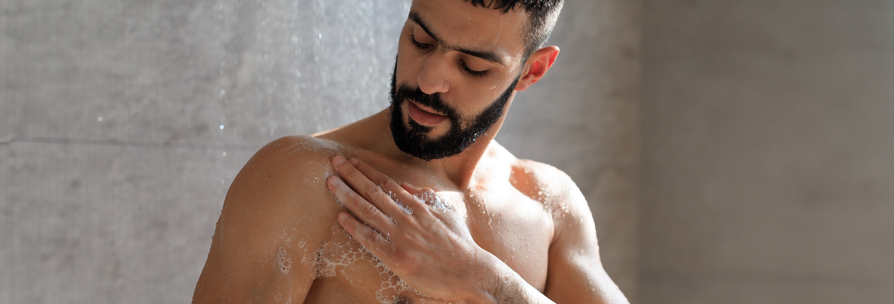 Man using body wash for sensitive skin in the shower