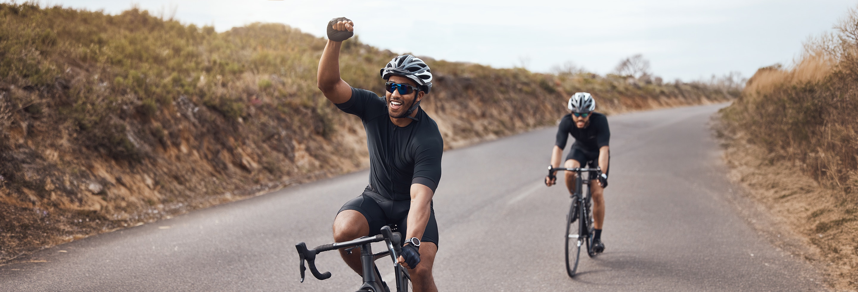 Man cycling with a friend with no sign of blocked sweat glands