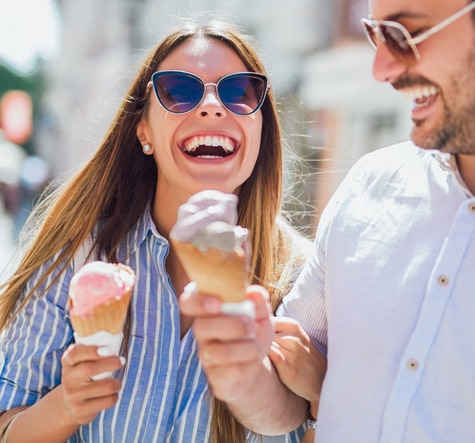 Happy couple enjoying Talenti Summer Gelato and Sorbetto outdoors in the sun
