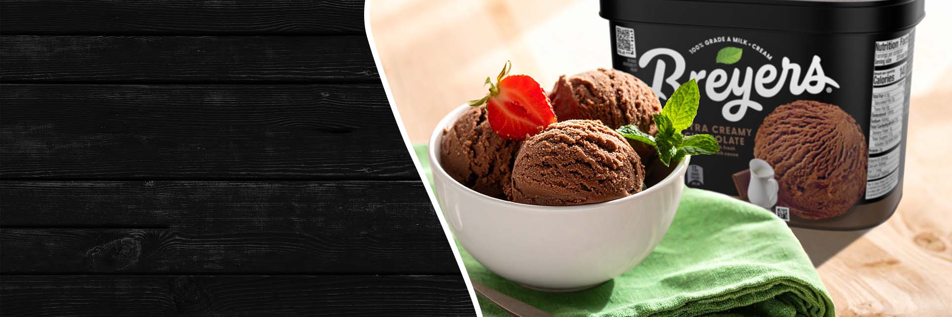 Bowl of chocolate ice cream next to a tub of Breyers Chocolate Ice Cream in a casual home 