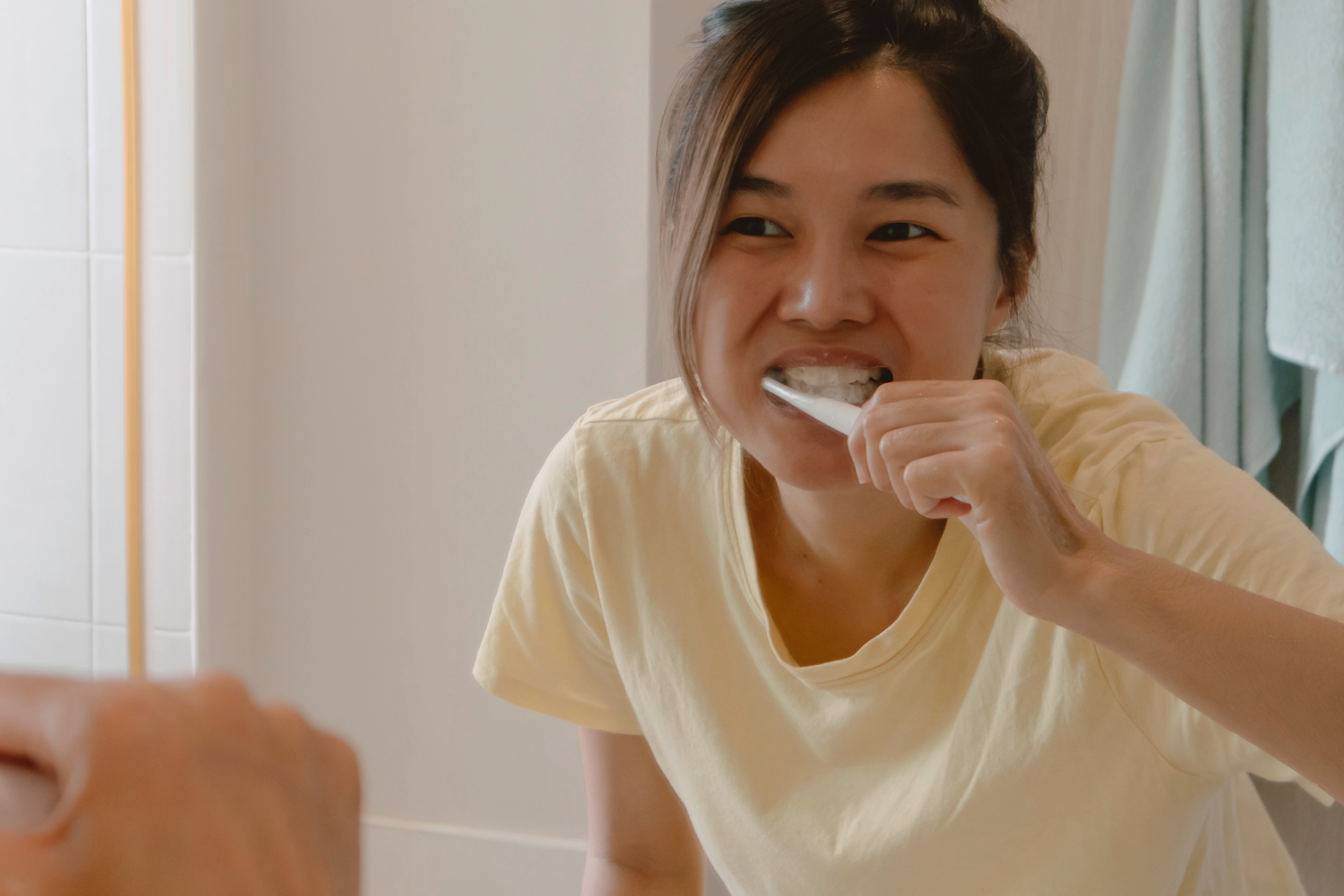 Woman brushing her teeth.