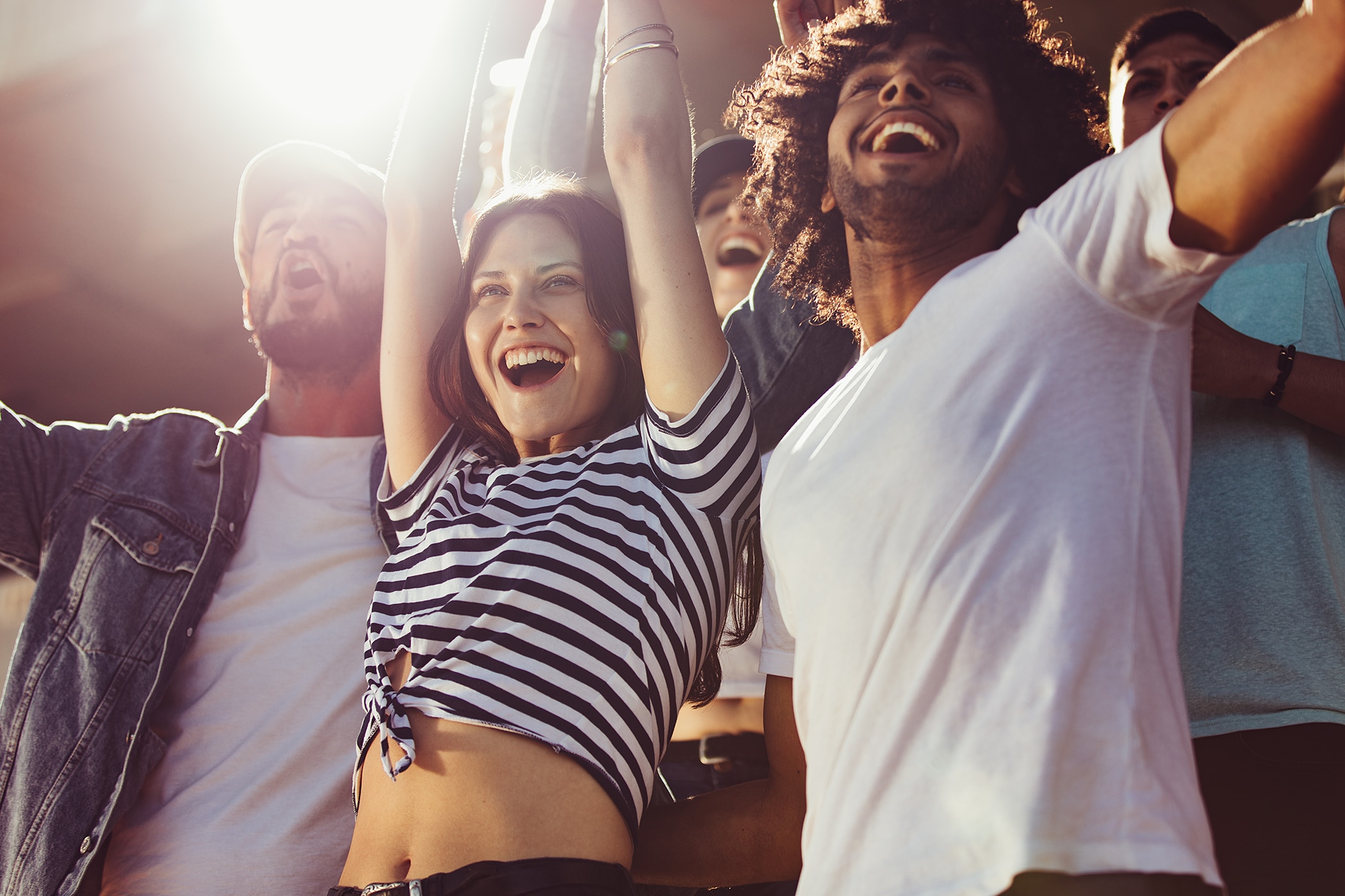 Group of happy fans cheering for their team while wearing deodorant that lasts&nbsp;