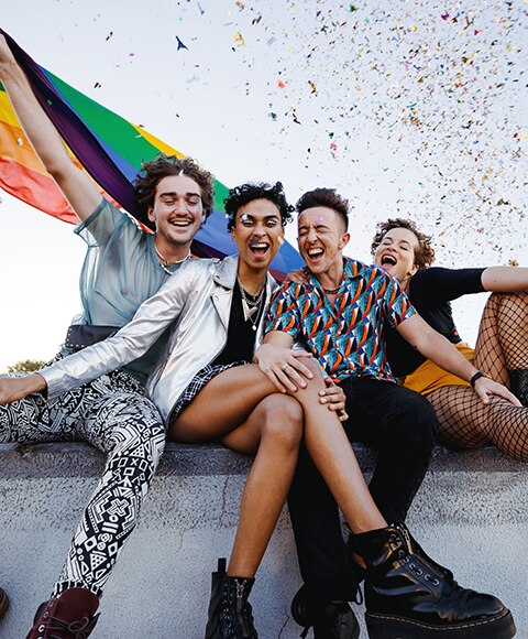 Alt: Group of LGBTQIA+ friends enjoying a Pride event 