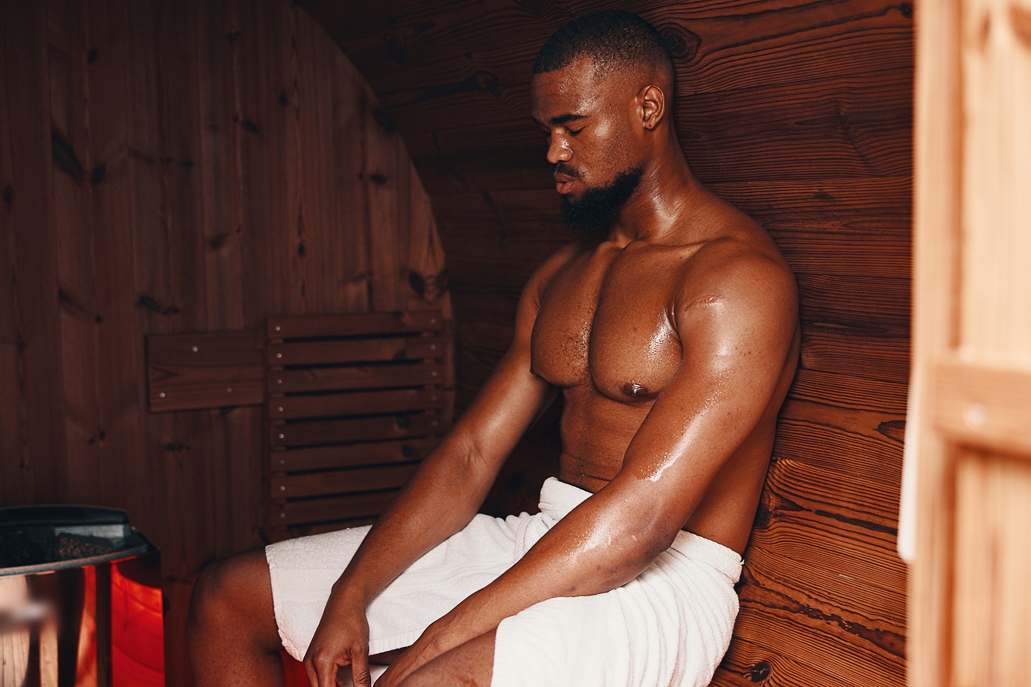 Young man enjoying the benefits of a sauna after a workout