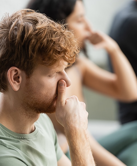 Couple practicing nostril breathing in a yoga studio