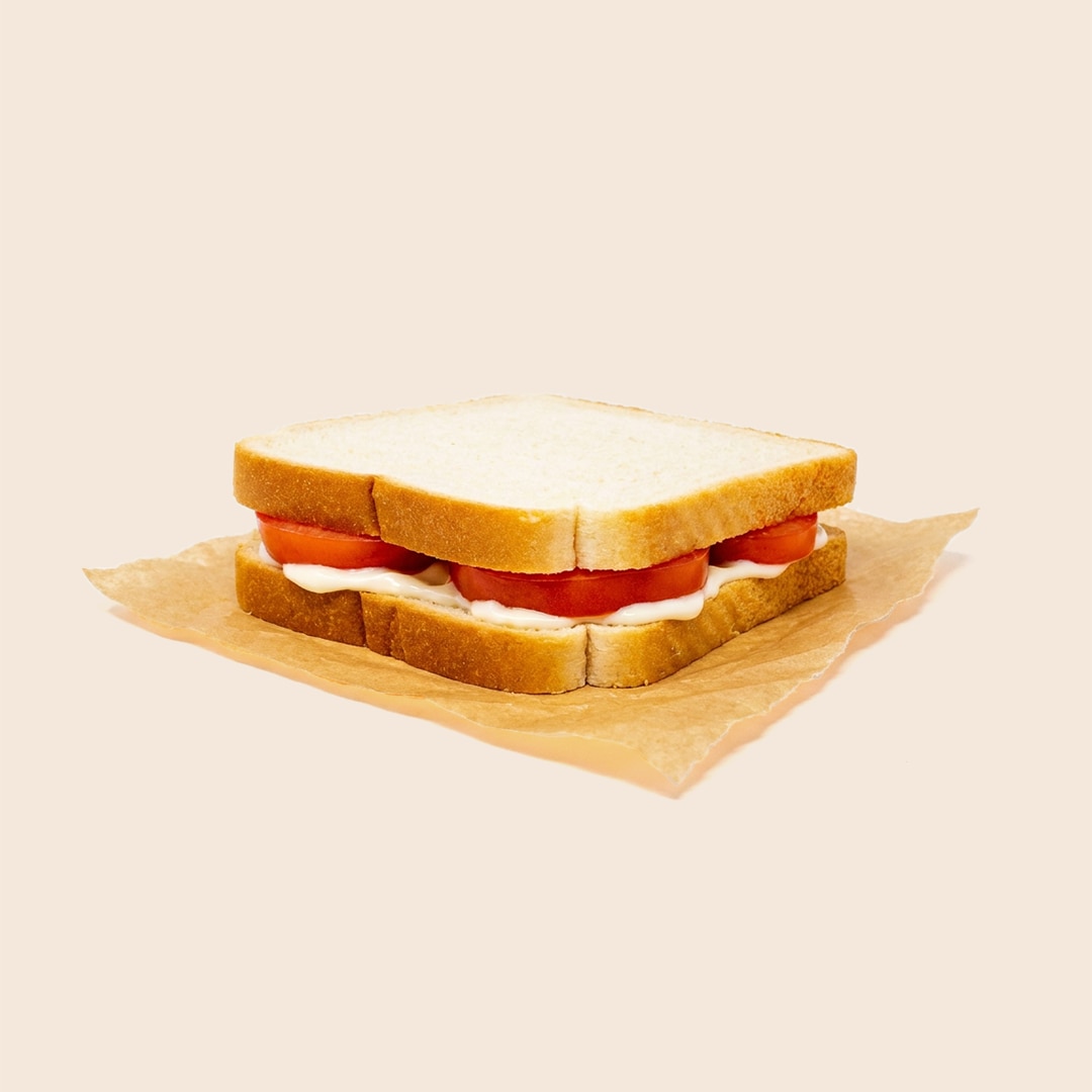 Simple southern tomato and mayonnaise sandwich on white bread.