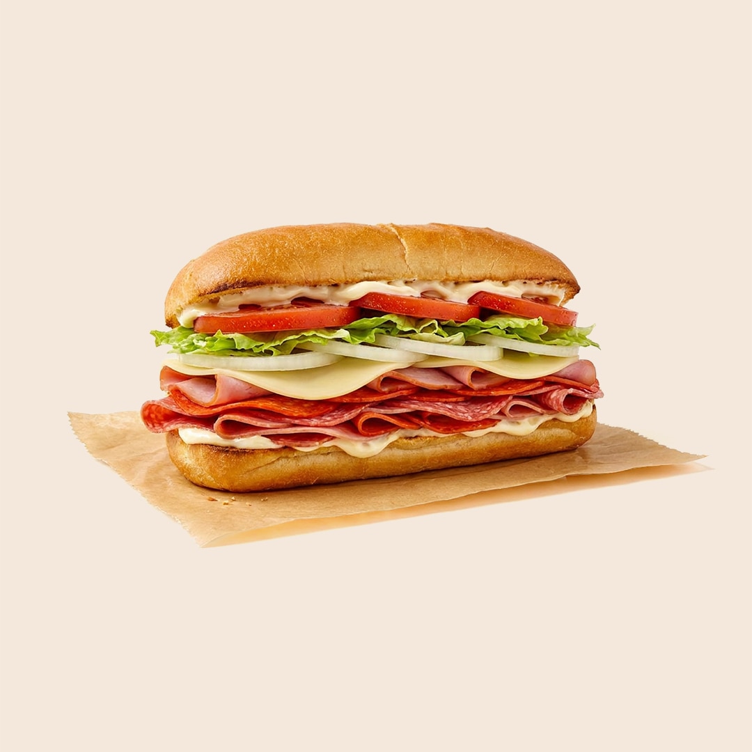 Submarine-style Italian hoagie with layers of cured meats, provolone cheese, lettuce, tomato, onion, and mayo.