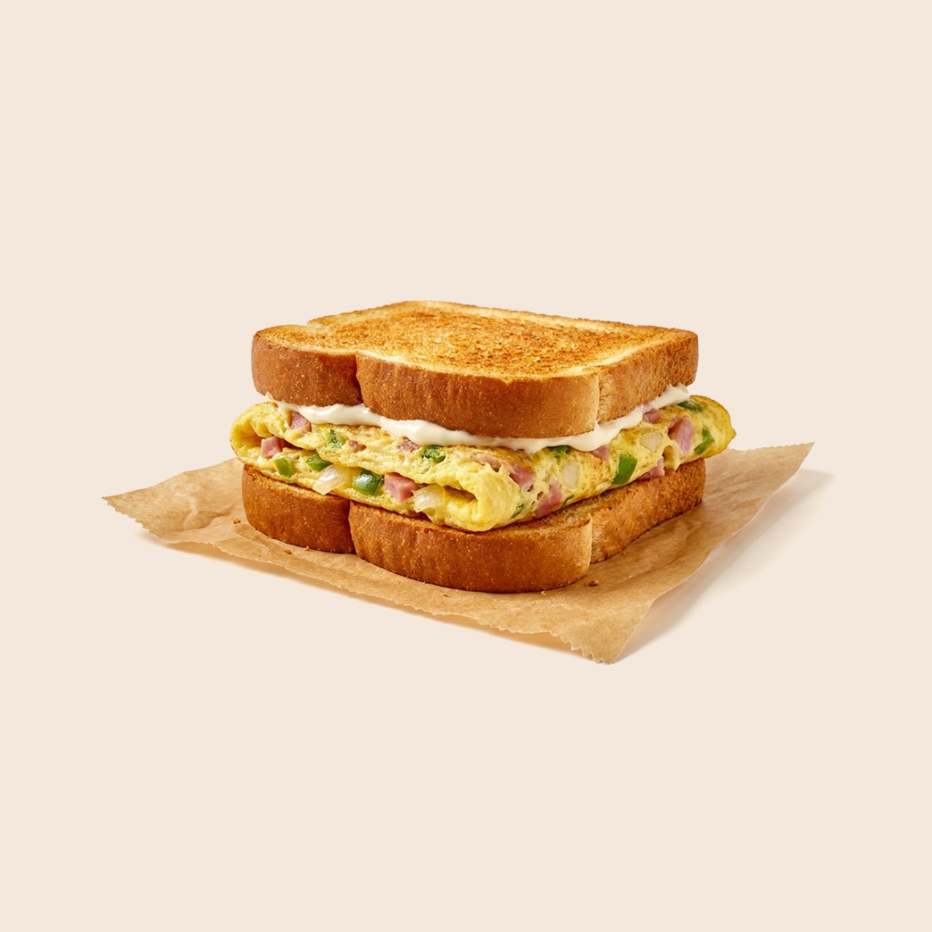 Denver omelette sandwich with ham, peppers, onions and mayo on toasted white bread.