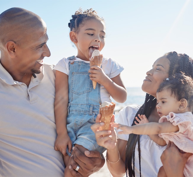 Family enjoying non-dairy ice cream outdoors on a sunny day
